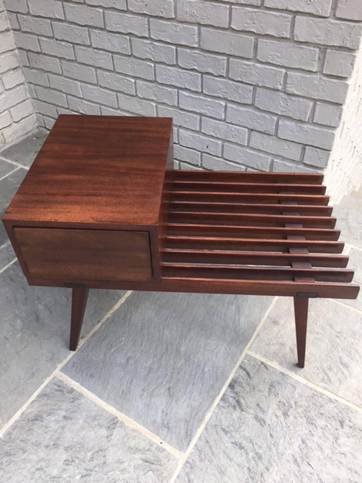 1960s side slat table or telephone table by Founders in mahogany. Professionally restored. The drawer has three angled pulls to allow access to open the drawer and the drawer is finished the same on both sides and can be slid open to either side.