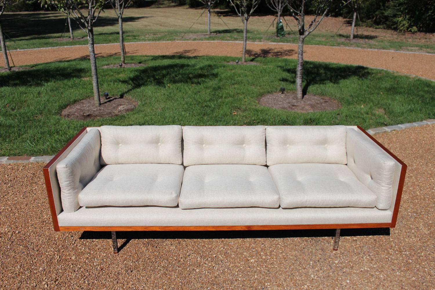 Rare three-sided teak wrapped sofa with stainless steel legs with wood caps by Komfort of Denmark. Professionally restored and reupholstered in a heavy weight high end polyester cotton blend modern oatmeal fabric color. Makers mark (Komfort) is on