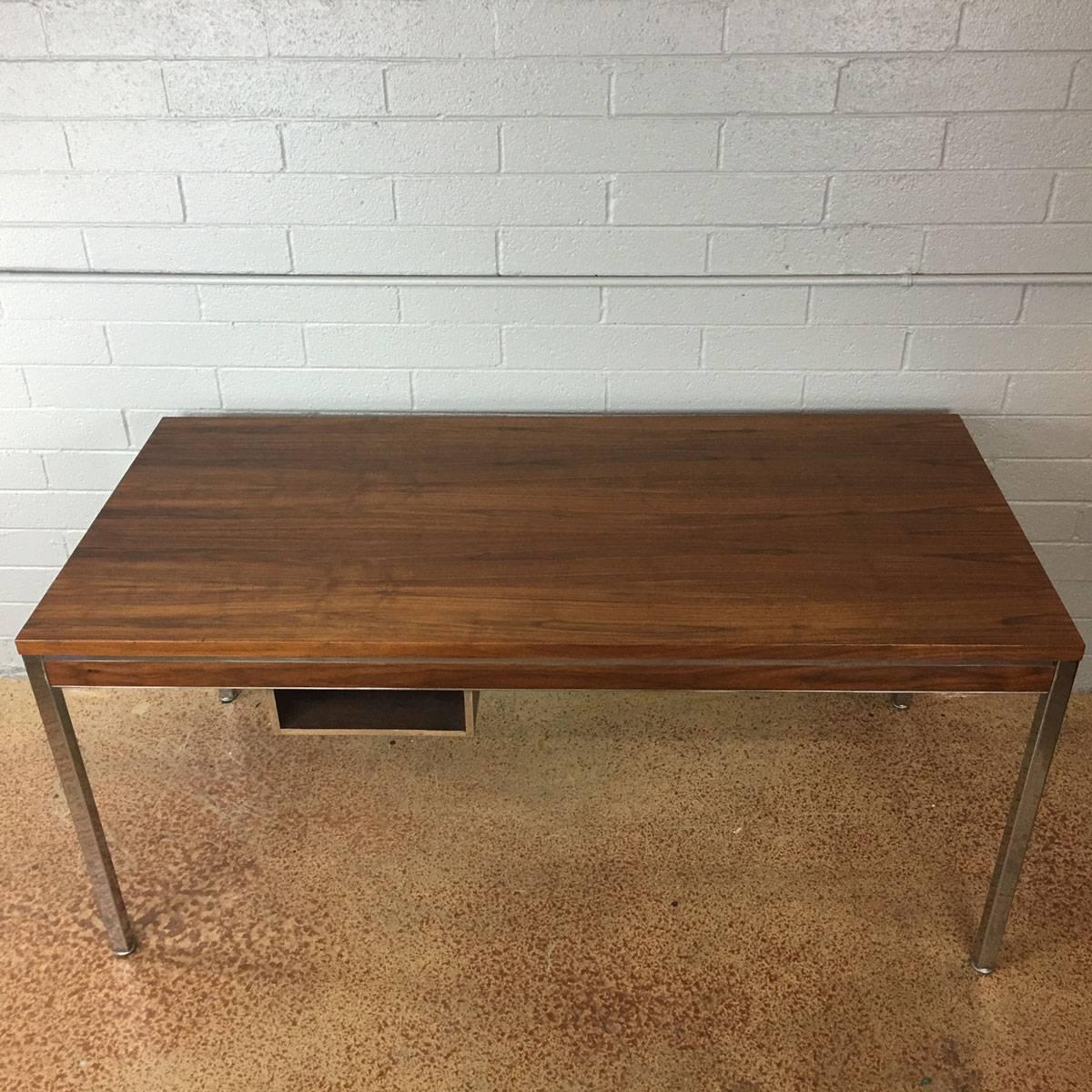 This beautiful simple walnut and chrome desk and also function as a small dining table or a conference table. Walnut top. Chrome accents with original glides. This unit may be Florence Knoll but it is no longer marked.