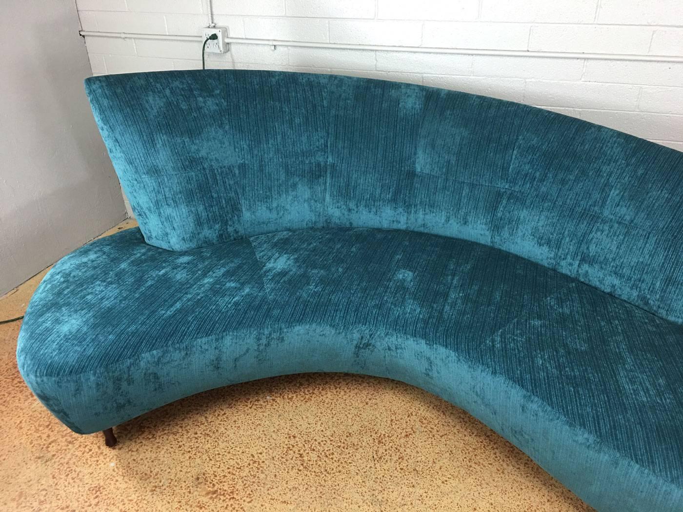 Stunning reupholstered Vladimir Kagan style serpentine cloud style sofa in a luxurious soft (but durable) peacock blue polyester blend high end fabric. It is likely that this Kagan style sofa is actually a Vladimir Kagan original. It is from the