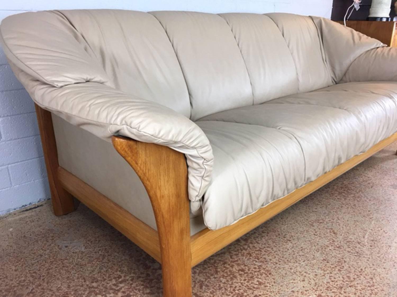 Superb, well built Ekornes leather sofa with wraparound teak frame. Soft. Supple. Very good condition. Circa 1970s. Seat height is 17.5".
