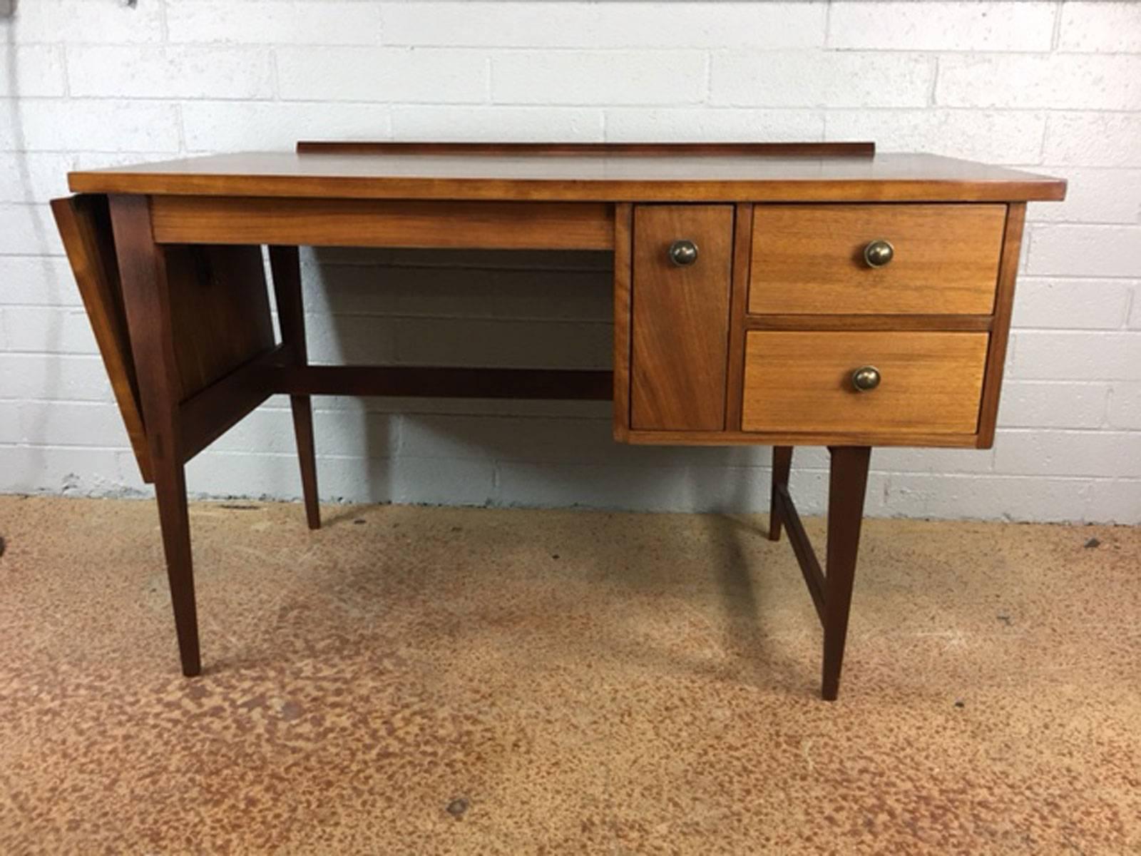 Unique drop-leaf desk by Lane Altavista in walnut. Refinished. Clean lines, circa 1960s. The drop leaf extends the width of the desk by another 16
