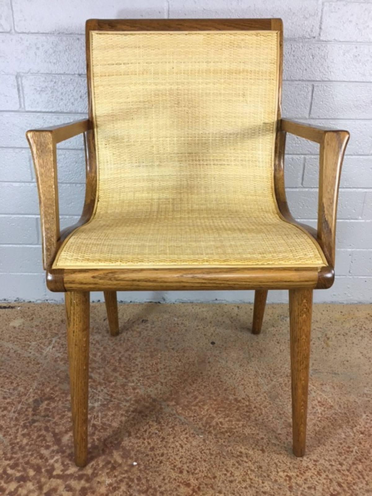Unique slipper chair in oak with new cane sling. Great lines. Elegant side chair, circa 1950s. No maker.