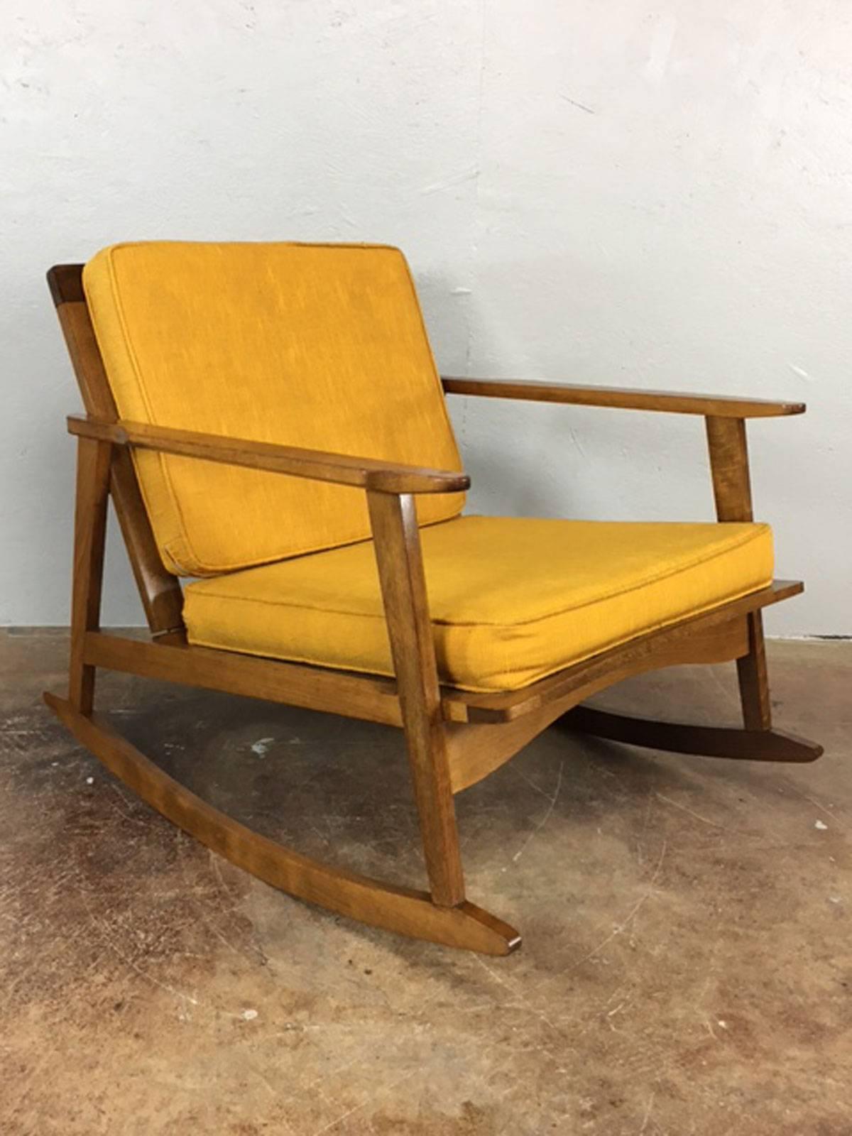 Danish style rocker lounge chair in walnut. Made in the former Yugoslavia republic. Solid. Original upholstery is useable. Easily changed if desired.