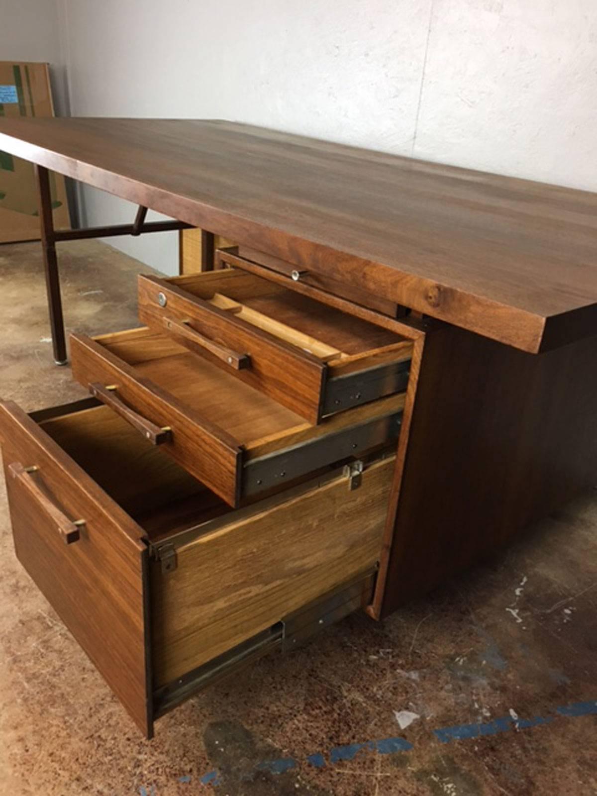 Very large executive desk with cane front modestry panel. Unattributed but believed to be Danish. Excellent craftsmanship. Fine walnut pulls.