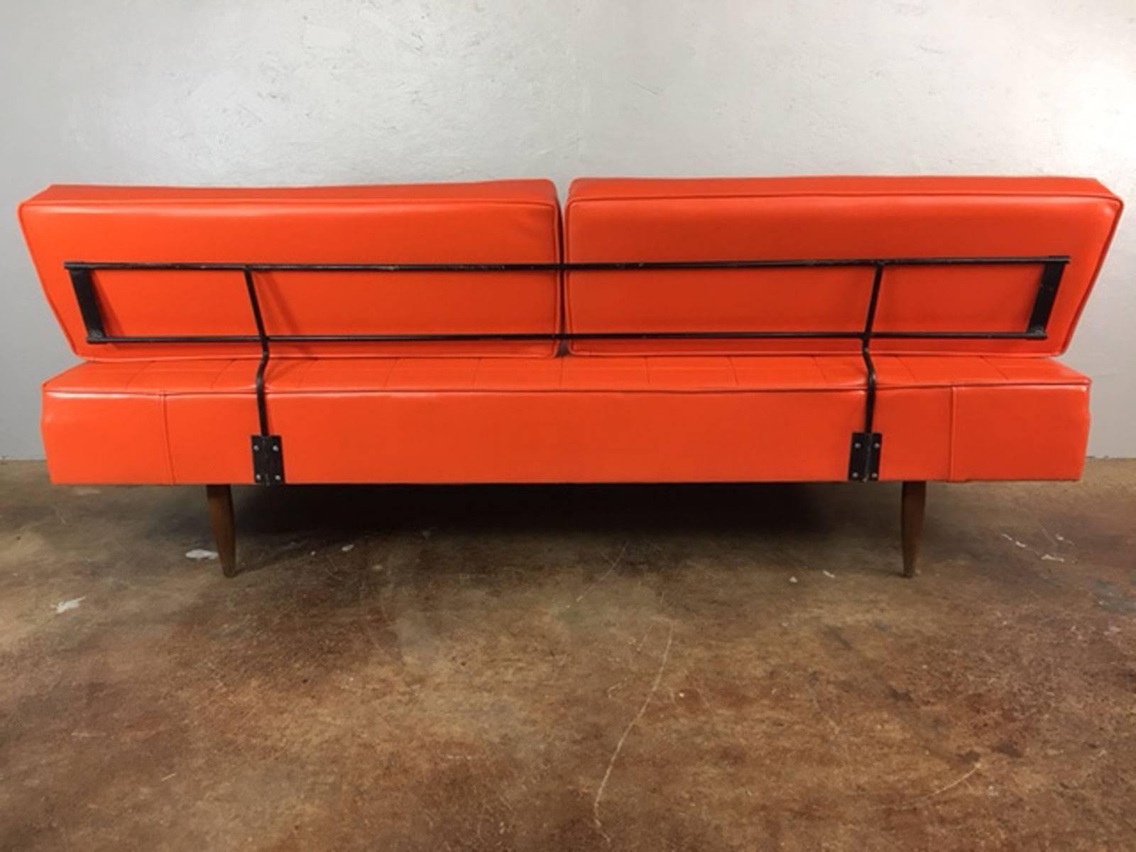 Superior and functional Mid-Century Modern daybed in original bright orange Naugahyde with wood frame, legs, and metal accents. No rips, tears, holes, or unusual wear. U.S. maker. circa 1960s. Solid. sturdy.