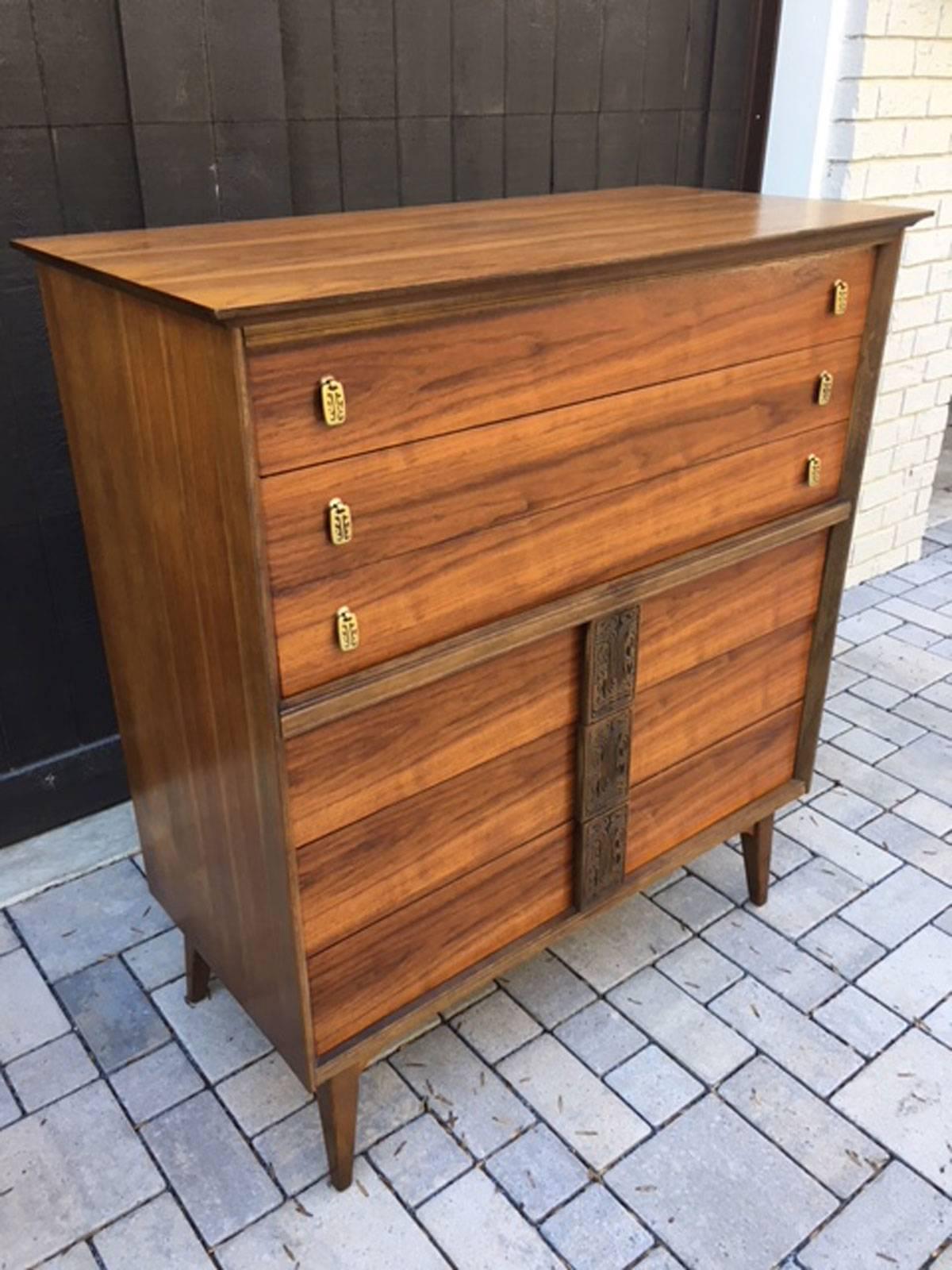 Unique Mid-Century Modern highboy dresser from the Mayan collection by Bassett. Refinished and very nice, circa 1960s. Walnut.