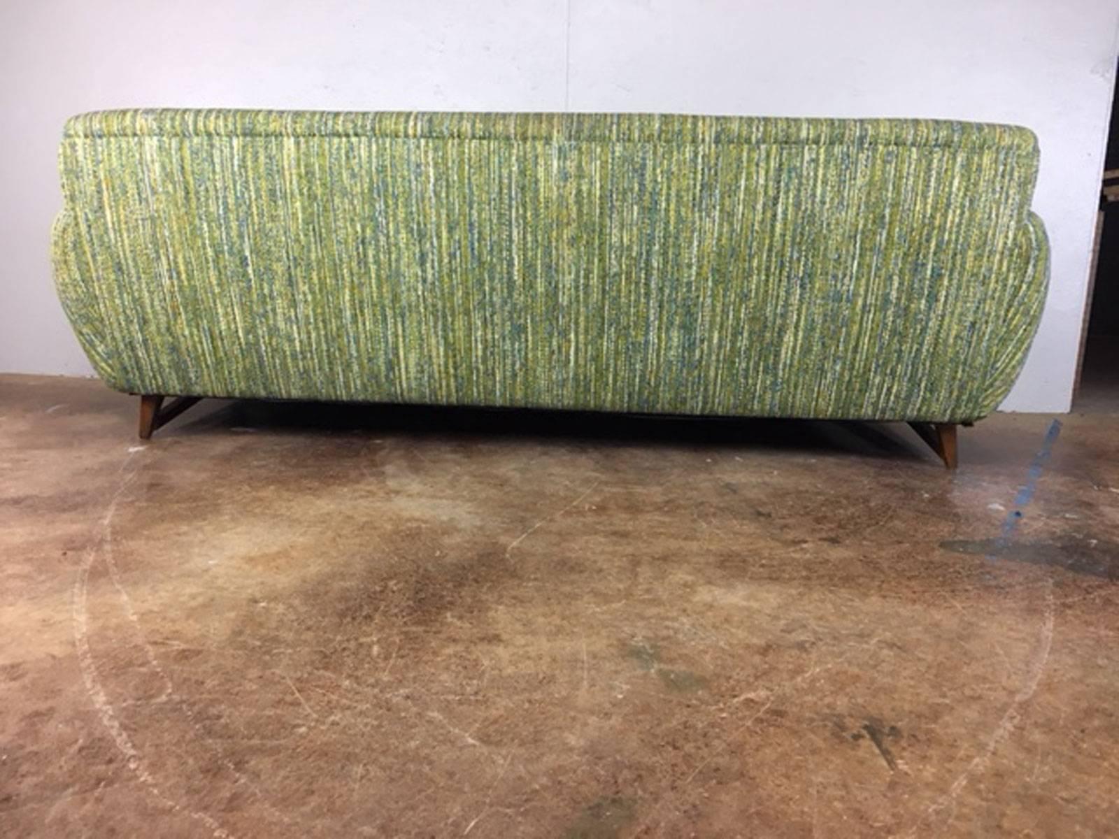 Superb Adrian Pearsall style Mid-Century Modern sofa with walnut side structure and legs and slant side armrests. Original fabric. No holes, tears, or unusual wear.