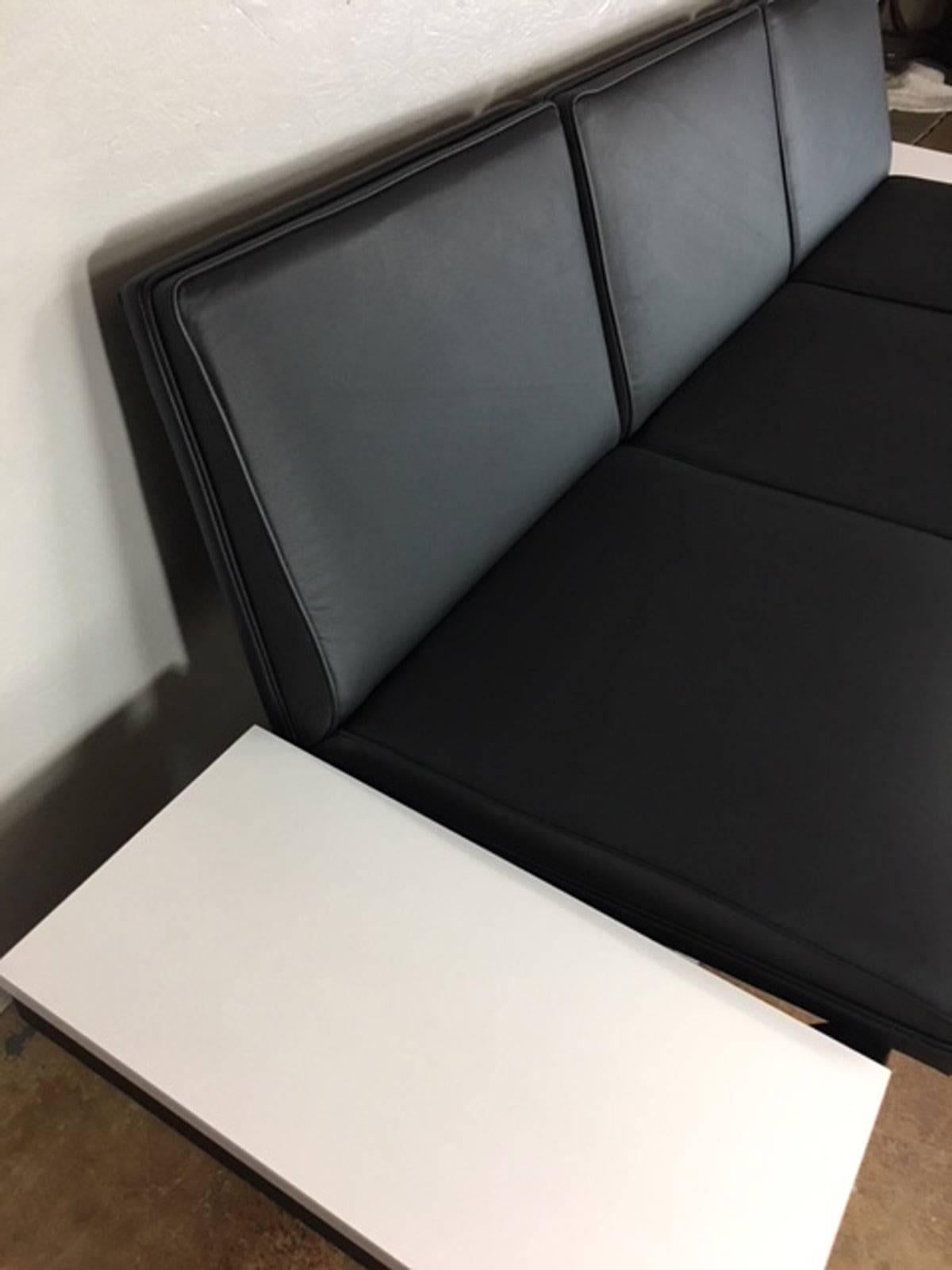 George Nelson steel frame sofa with new black leather and two white formica side tables. Seat height is 16 inches.