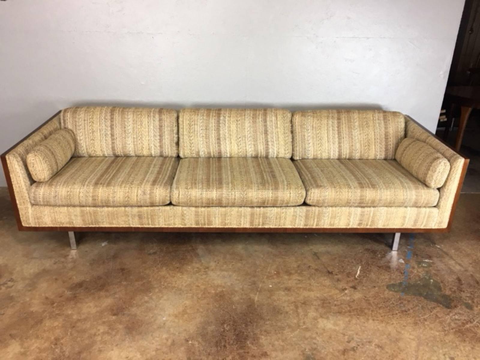 Unique walnut side case sofa by Milo Baughman with stainless steel legs. Sleek look on a low rise back sofa. Original upholstery. No rips, holes, tears, or unusual wear. Use it as is or have us reupholster it in a modern, fresh look for $1,000 more.