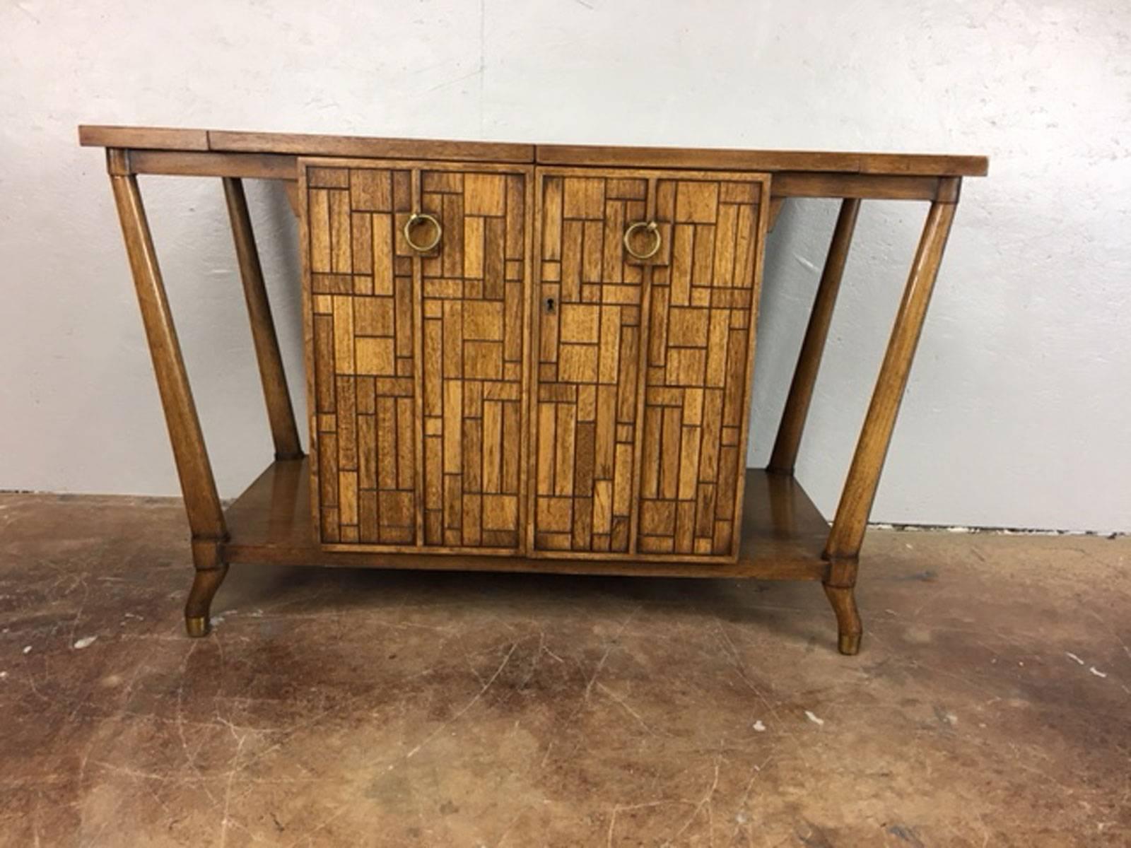 Beverage bar cart in walnut by Johnson Furniture Co. Both sides flip over for extended serving space. The width when not fully open is 42 inches.