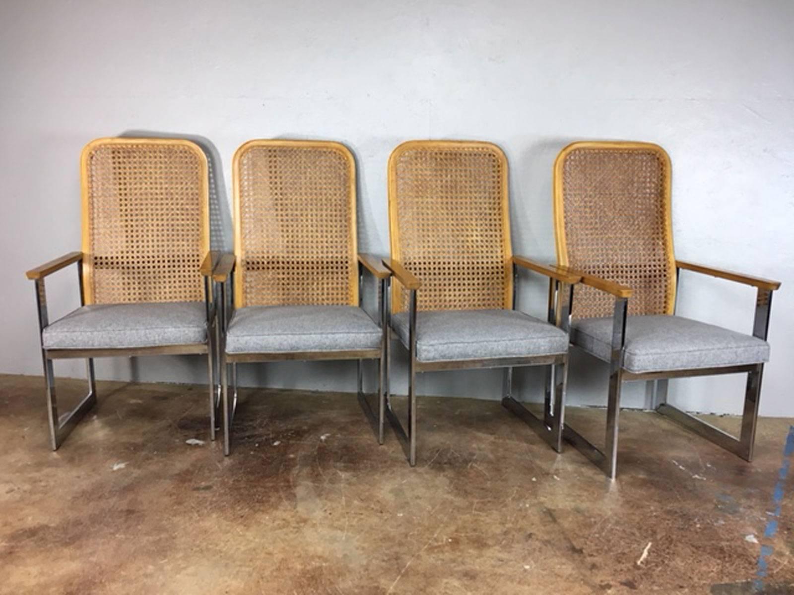 Unique set of four Milo Baughman cane back and chrome dining chairs. Reupholstered in a new, soft, luxurious, and long wearing and easy to clean 100% polyester modern grey fabric. Seat height is 17 inches.
