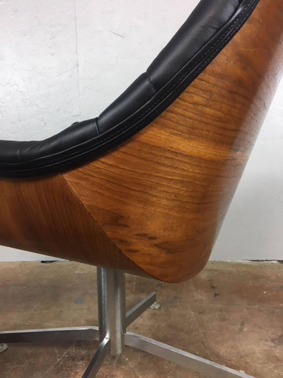 Black leather diamond patterned lounge chair in walnut. New black leather. Very unique and unusual chair. Refinished and refurbished. Measures: Seat height is 16 inches.