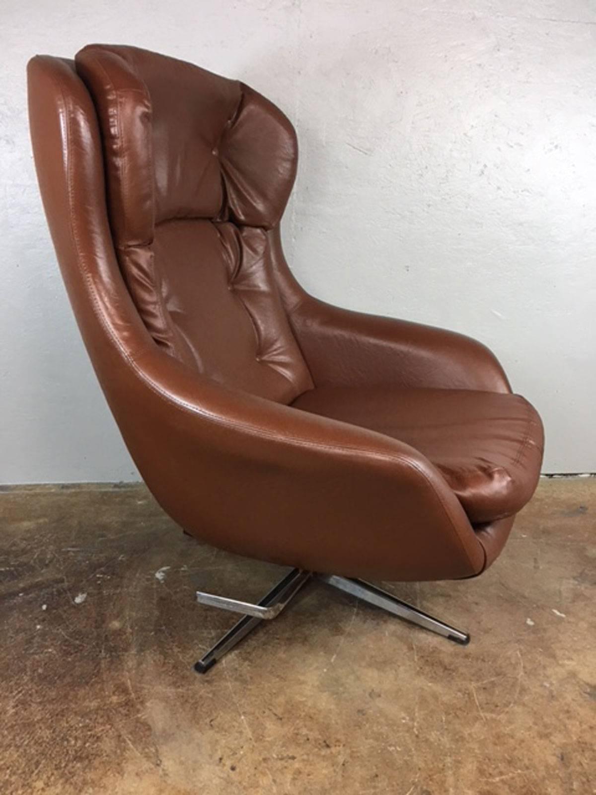 1960s brown leather lounge chair and ottoman by Selling. All original. No rips, tears, holes, or unusual wear. One leg is missing the plastic CAP covering as shown in pic. Seat height is 15.5 inches. Ottoman measures 25 inches wide x 18 inches deep