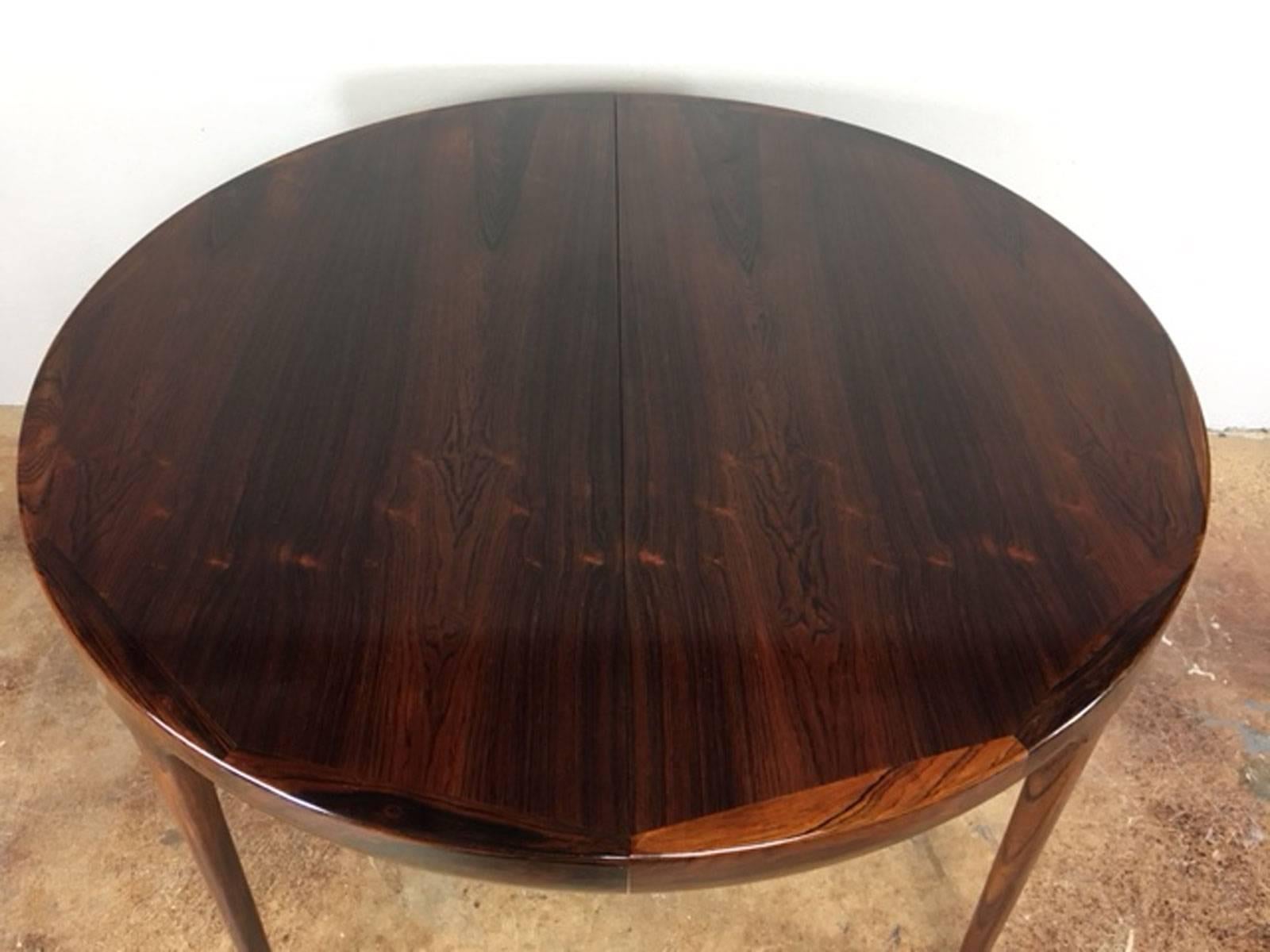Ib Kofod-Larsen rosewood dining table with three extension leaves. Each leave is 19.5 inches and when used increases the table width from 47 inches to 105.5 inches. Excellent condition.