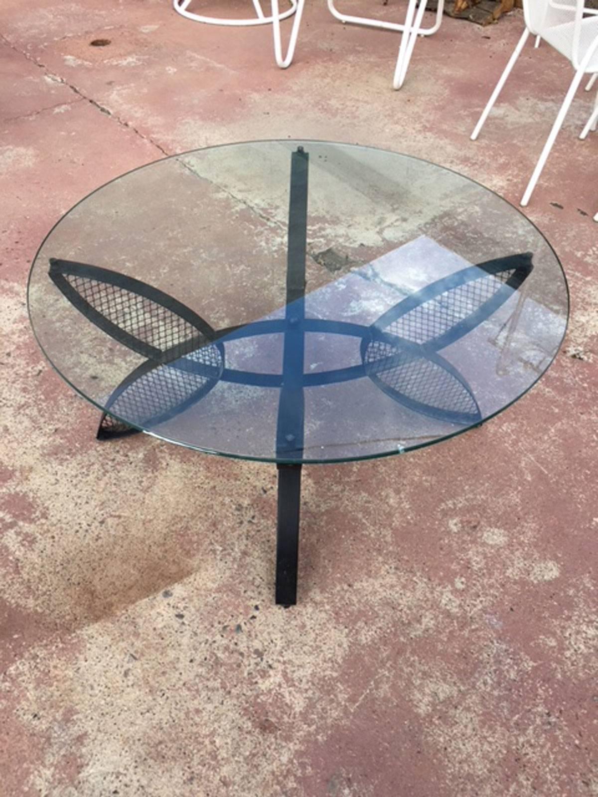 Maurizio Tempestrini for Salterini coffee table with clear half inch glass. Black forged iron butterfly bases. All original condition.