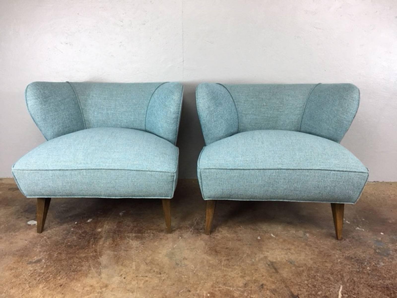 Extraordinary low profile pair of Mid-Century Modern club chairs reupholstered in one of the new modern and luxurious fabrics out of California that are 100% polyester for easy cleaning and long wear. Soft and attractive, the new polyesters are