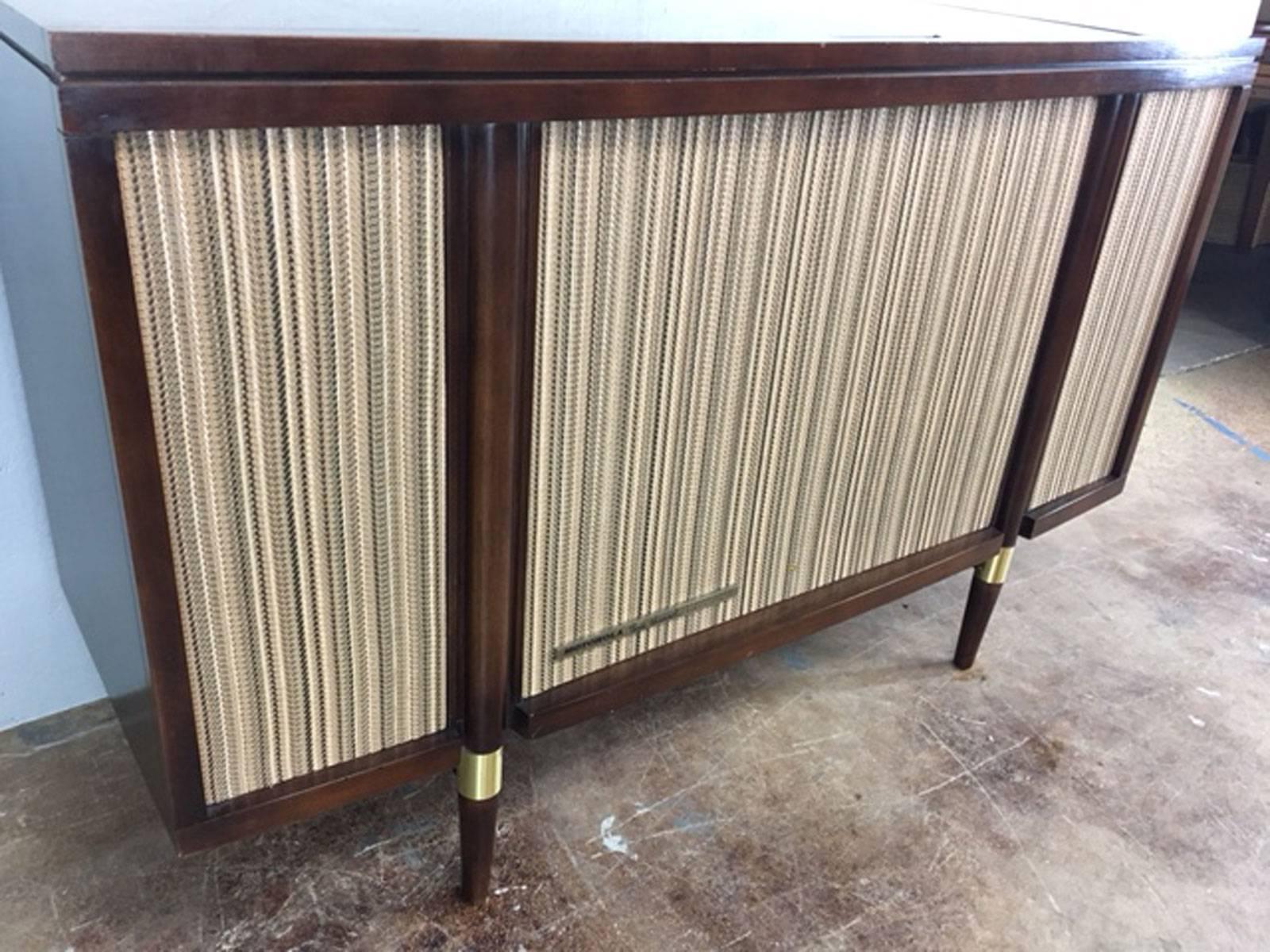 Motorola 3 channel stereophonic high fidelity stereo console. Original condition outside. The inside stereo components, however, have all been professionally serviced and are in excellent working order. Woofer in centre and woofers and tweeters on