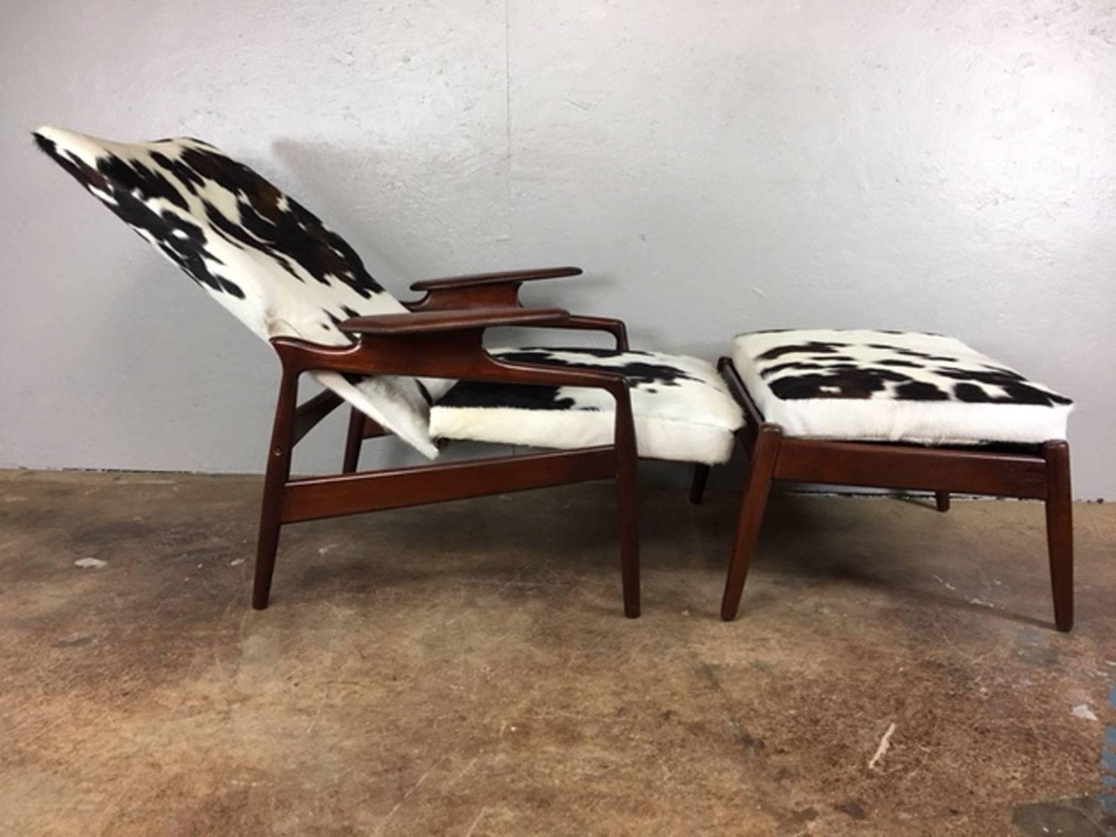 Teak reclining high back lounge chair and ottoman attributed to Finn Juhl. Newly upholstered in a spunky cowhide leather. Like many other Danish designed chairs of this era, this chair 