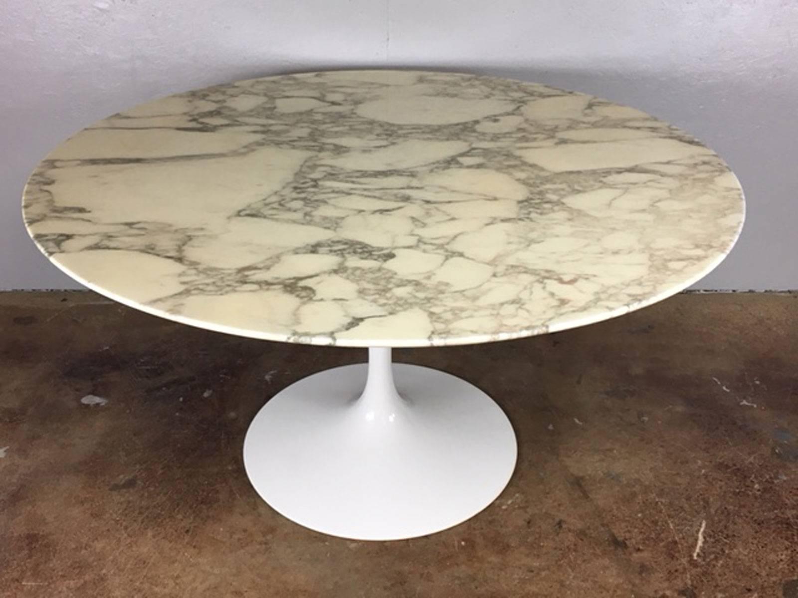54 inch diameter Eero Saarinen tulip base marble-top dining table for Knoll. Exceptional original condition. The wool rug (made in Germany) is also available for $950.