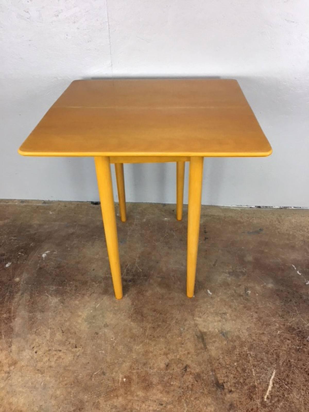 Unique Heywood Wakefiled folding top game or dining table for smaller spaces. Original acquisition condition. Solid maple. This table is in very useable original acquisition condition or easy to refinish if desire a perfect finish. Without the
