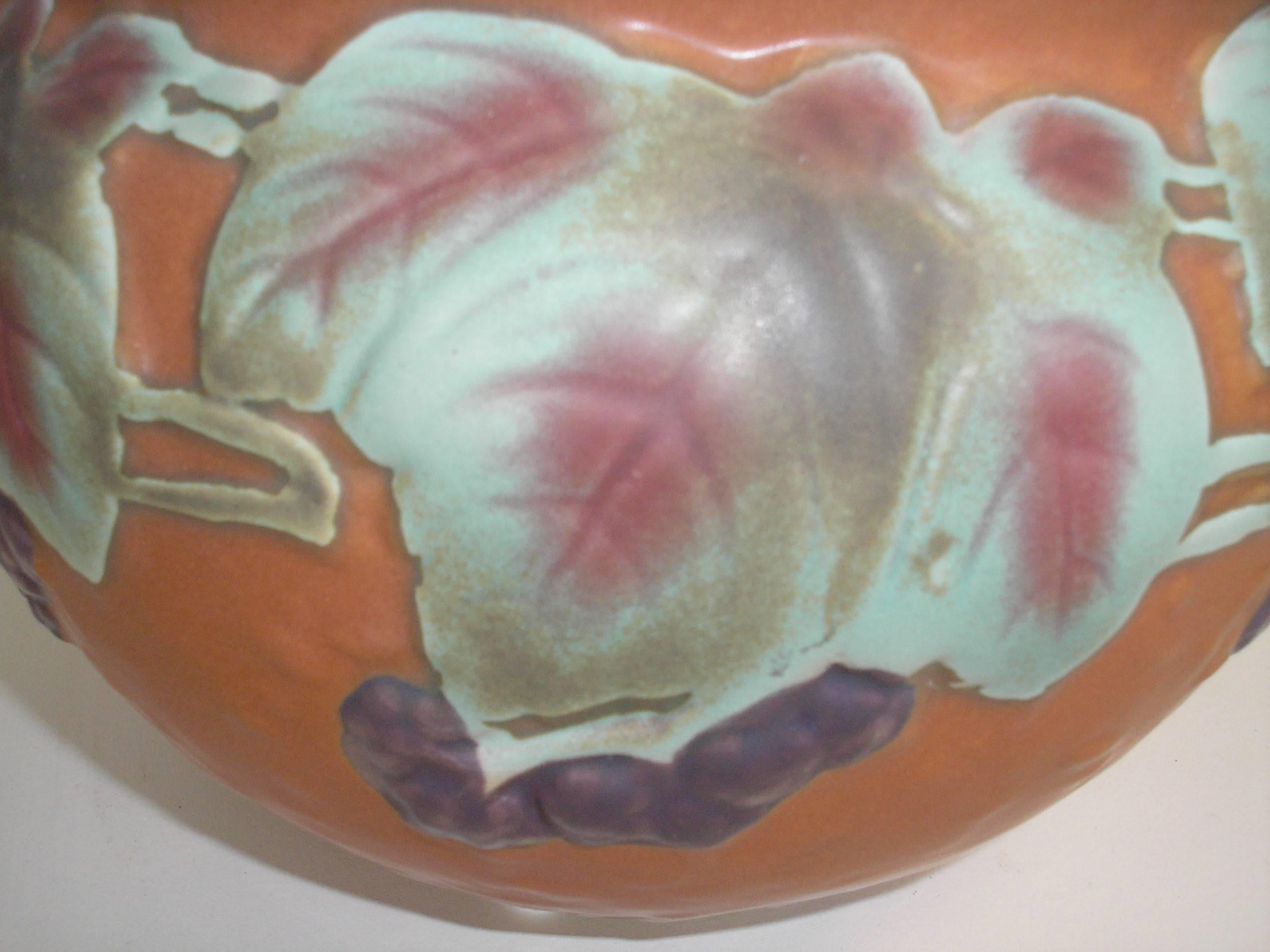 Roseville pottery bowl/urn with grape motif. Two small handles. Signed on the bottom, circa 1960. Excellent condition.