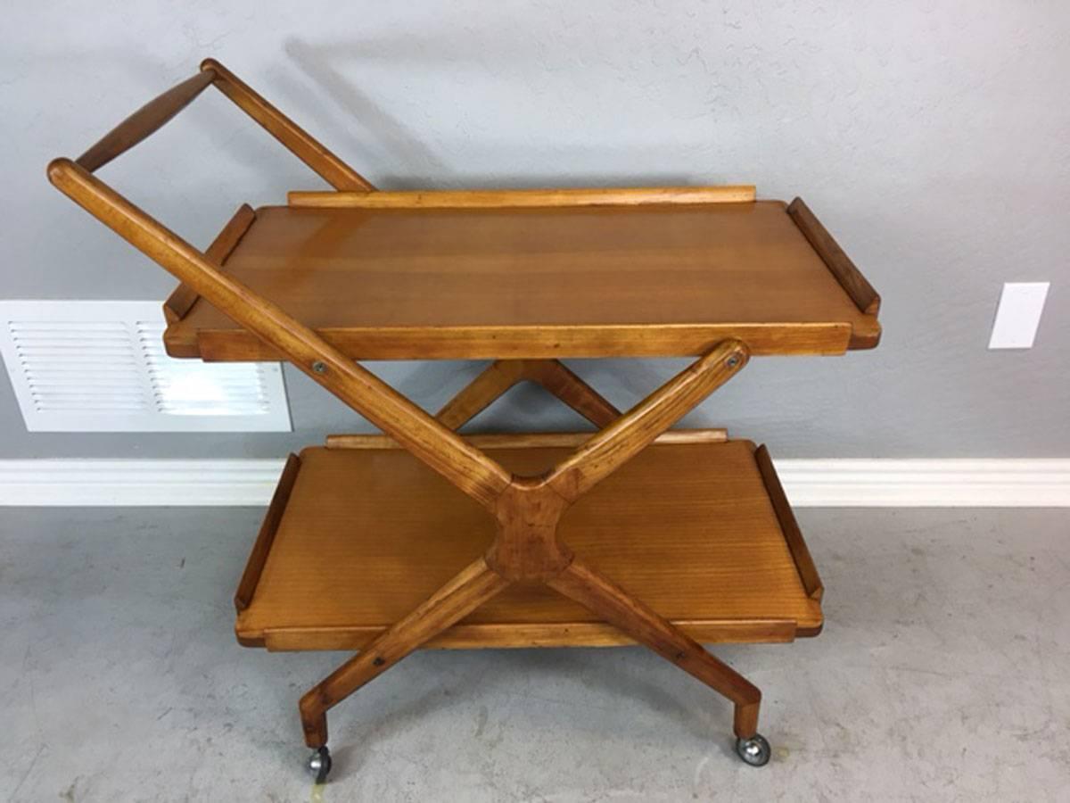 Mid-Century Modern bar cart made of fruitwood acquired from Italy. Very well constructed. Classy. Sophisticated.