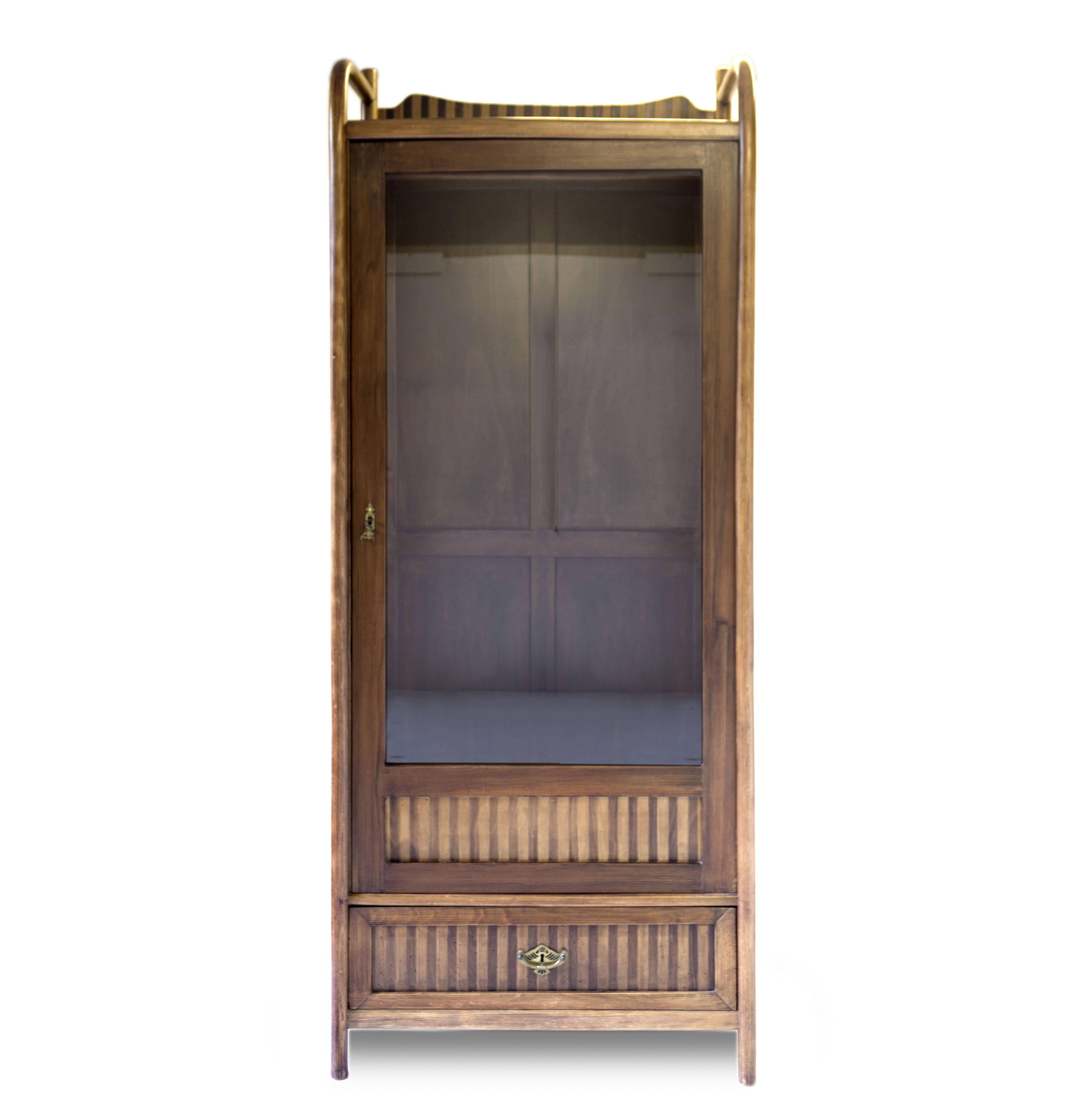 Elegant and beautiful wardrobe by Jacob and Joseph Kohn in bentwood.
The wardrobe as an elegant stripe motive made by two different kind of wood.
One drawer on the bottom and a mirror door.