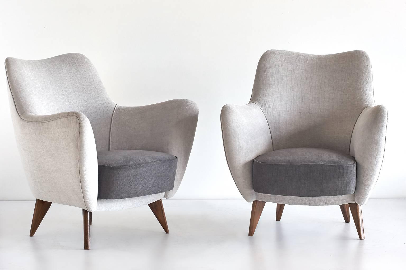 A pair of 'Perla' armchairs designed by Giulia Veronesi and produced by ISA Bergamo, Italy. Its sensual curves and the elegantly tapered legs give the chair a sculptural and modern feel. These sumptuous armchairs are upholstered in a bicolour velvet