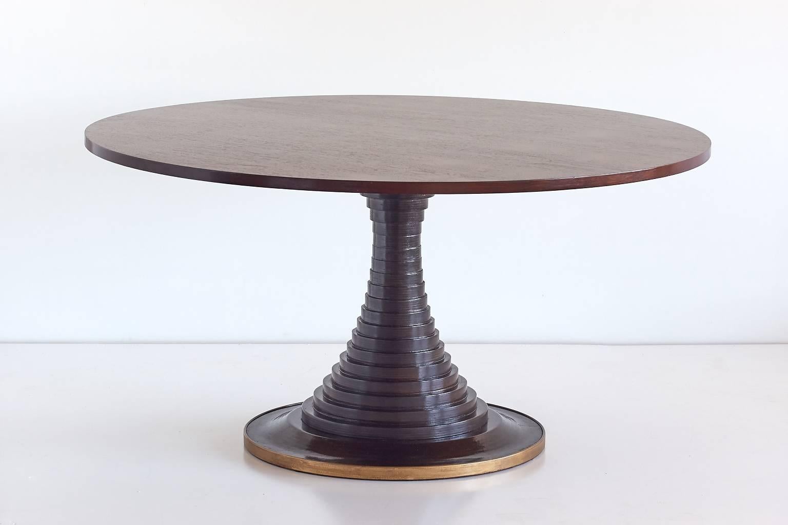 This rare and generously sized table was designed by Carlo de Carli and produced by Sormani in 1963. The beautiful top made of teak stands on a striking base made of solid wooden discs, with a circular brass trim detail. The elegant "Model