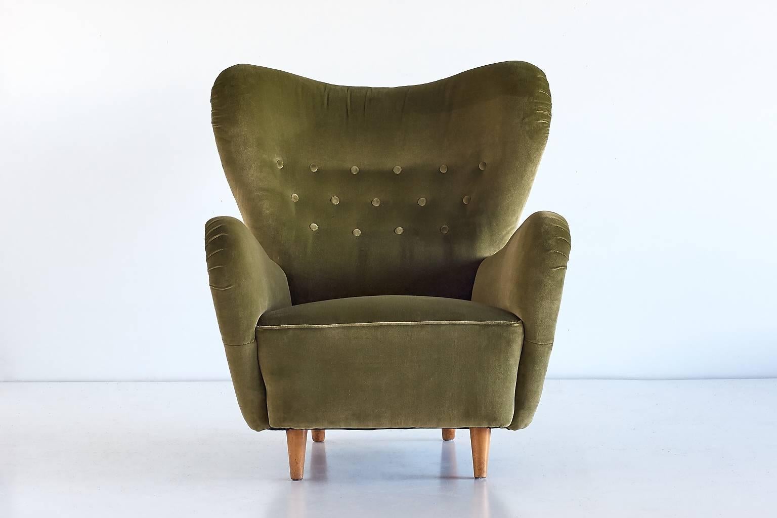 This rare high back armchair was designed by Otto Schultz and produced by Boet in Göteborg, Sweden, 1946. The elegant organic lines of the design create a striking Silhouette. Its generous proportions, the high back and the soft green velvet