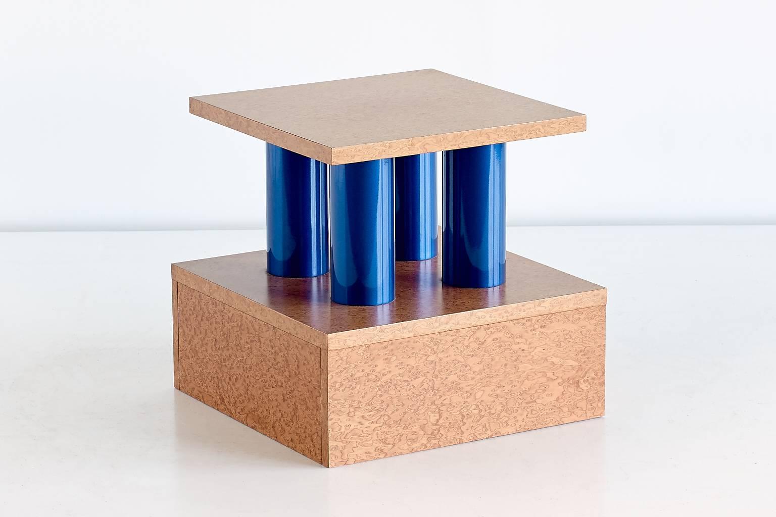 This rare side table was designed by Ettore Sottsass and Marco Zanini in 1985. The wooden parts, executed in bird’s eye maple, offer a striking contrast with the four blue metal tubes on which the table top is resting. Part of the 'Donau' series,