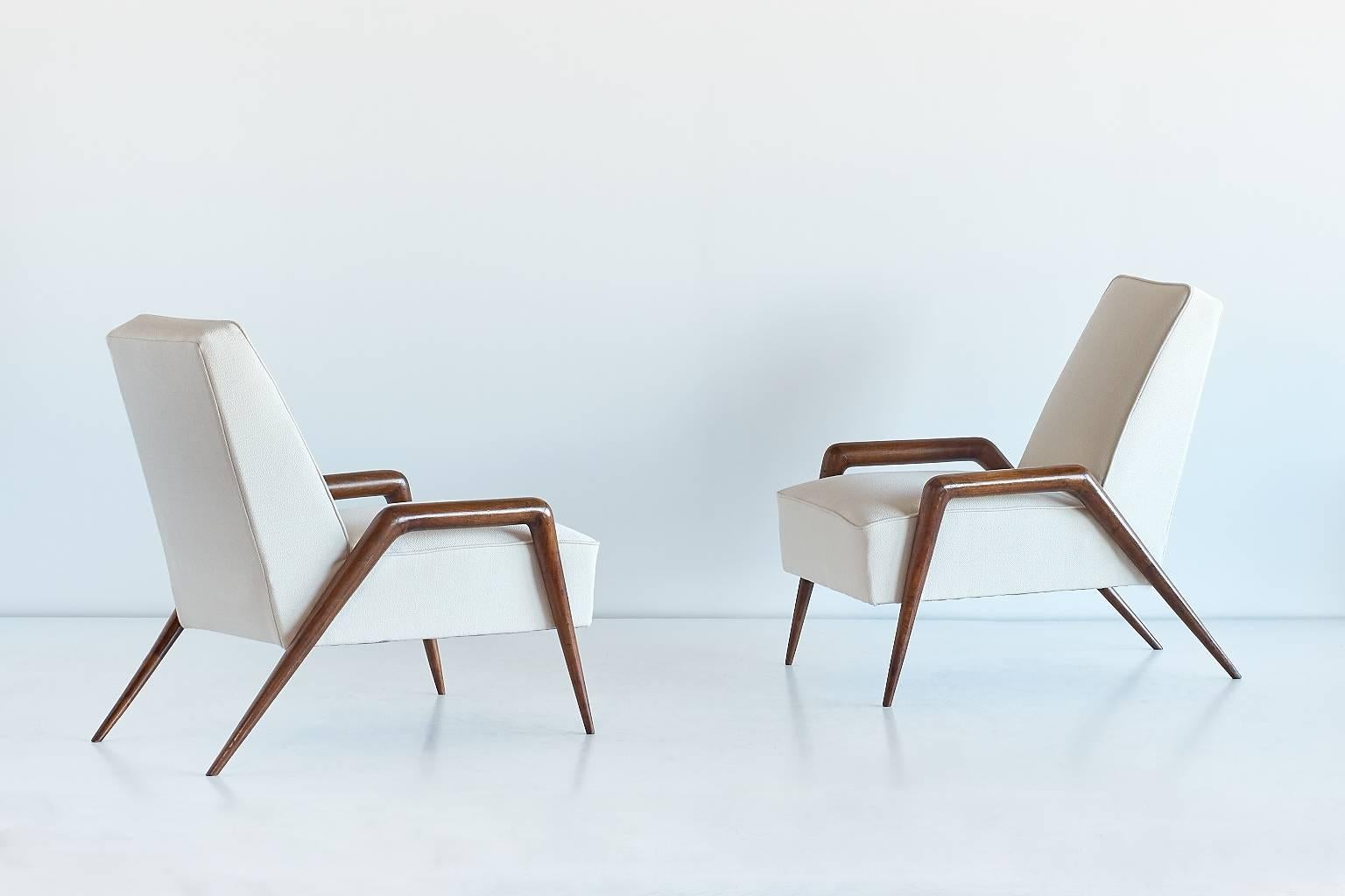 These striking armchairs were designed and custom-made by Tito Bassanesi Varisco for the private residence of the Zuffellato family in Milan. The solid walnut frames give the chairs a modern and highly original feel. The particularly graphical lines
