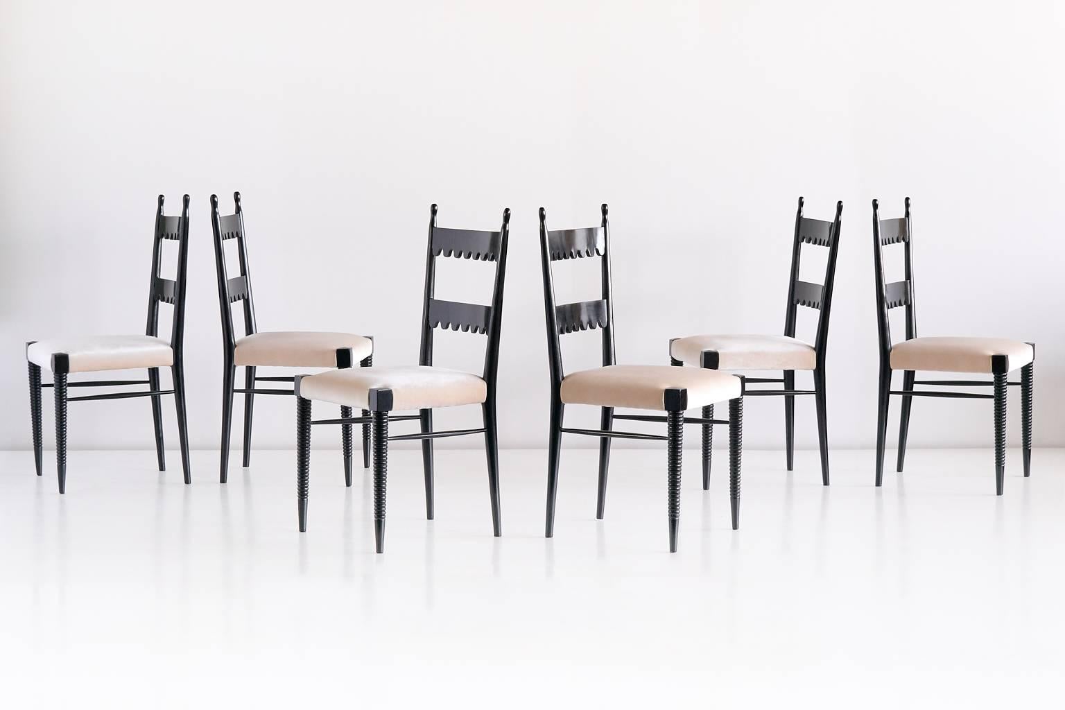 A rare set of six dining chairs designed by Pier Luigi Colli and produced by his company Colli in the late 1940s. The black lacquered chairs are characterized by the scalloped pattern and carved finials on the backrests, and the carved front legs. A