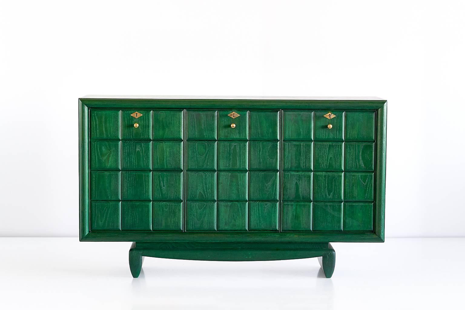 This green buffet cabinet was custom designed for a private palazzo residence in Florence. Made in the late 1930s, it was part of a dining room which had an entirely green decor.
The three door panelled cabinet is executed in solid elm and oakwood,