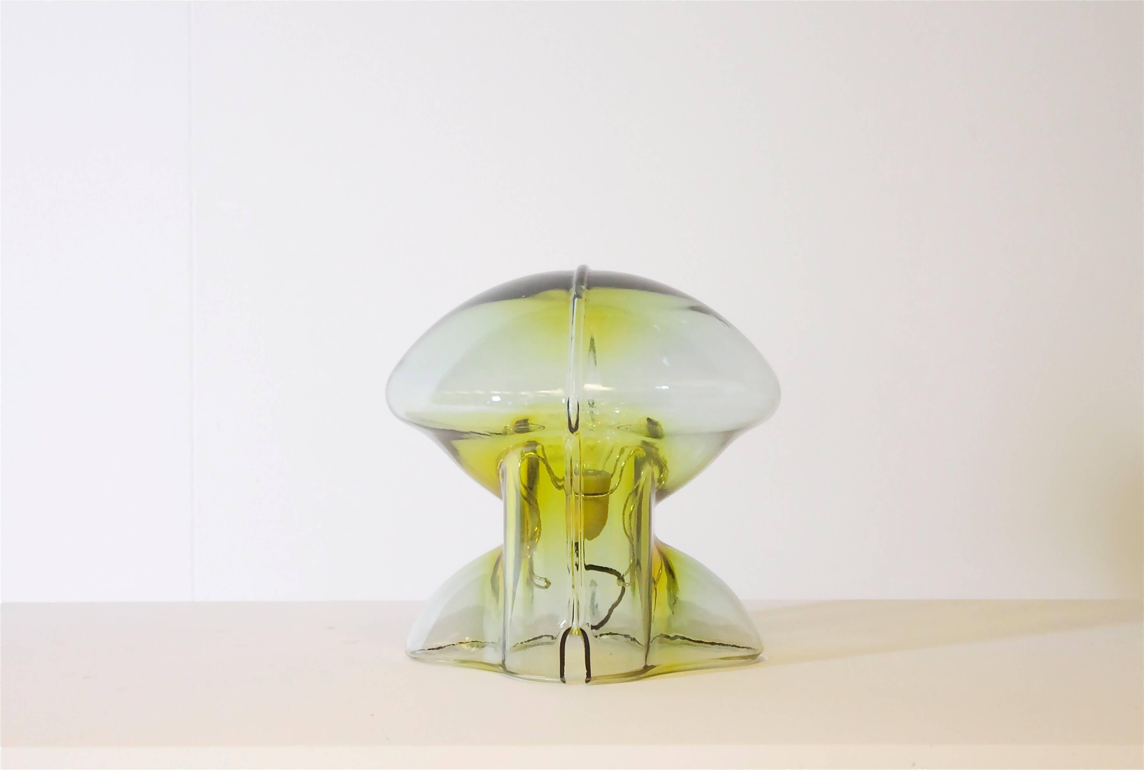 Rare Medusa table lamp for VeArt, Italy.

Designed by the Italian architect and designer Umberto Riva.

The lamp consists of thick handmade green and amber colored glass which gives a stunning light effect.

Porcelain light socket which is held in