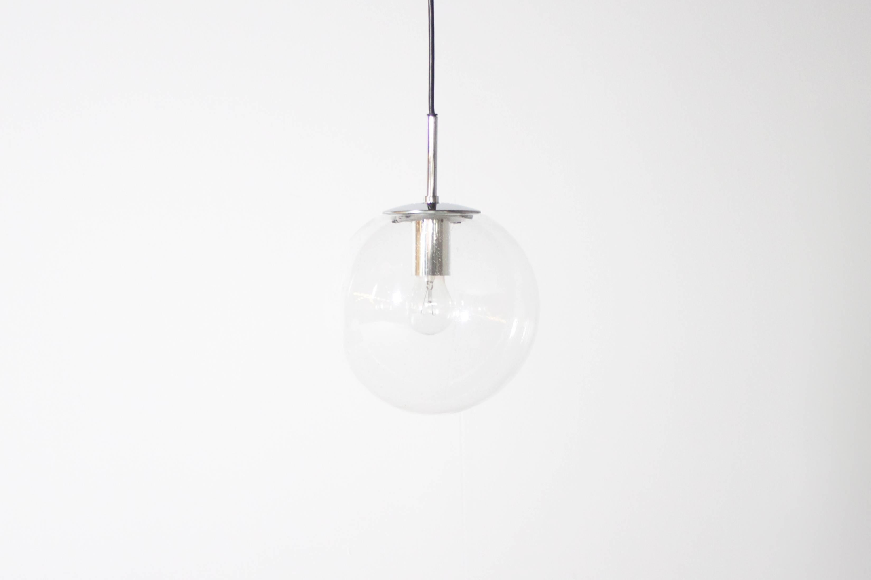 Glashütte Limburg pendants in beautiful condition. 

Chromed hardware. 

Handblown transparent bubbled glass globes which create a wonderful light effect.

Black cord and original canopy. 

The length of the cord can be customized for