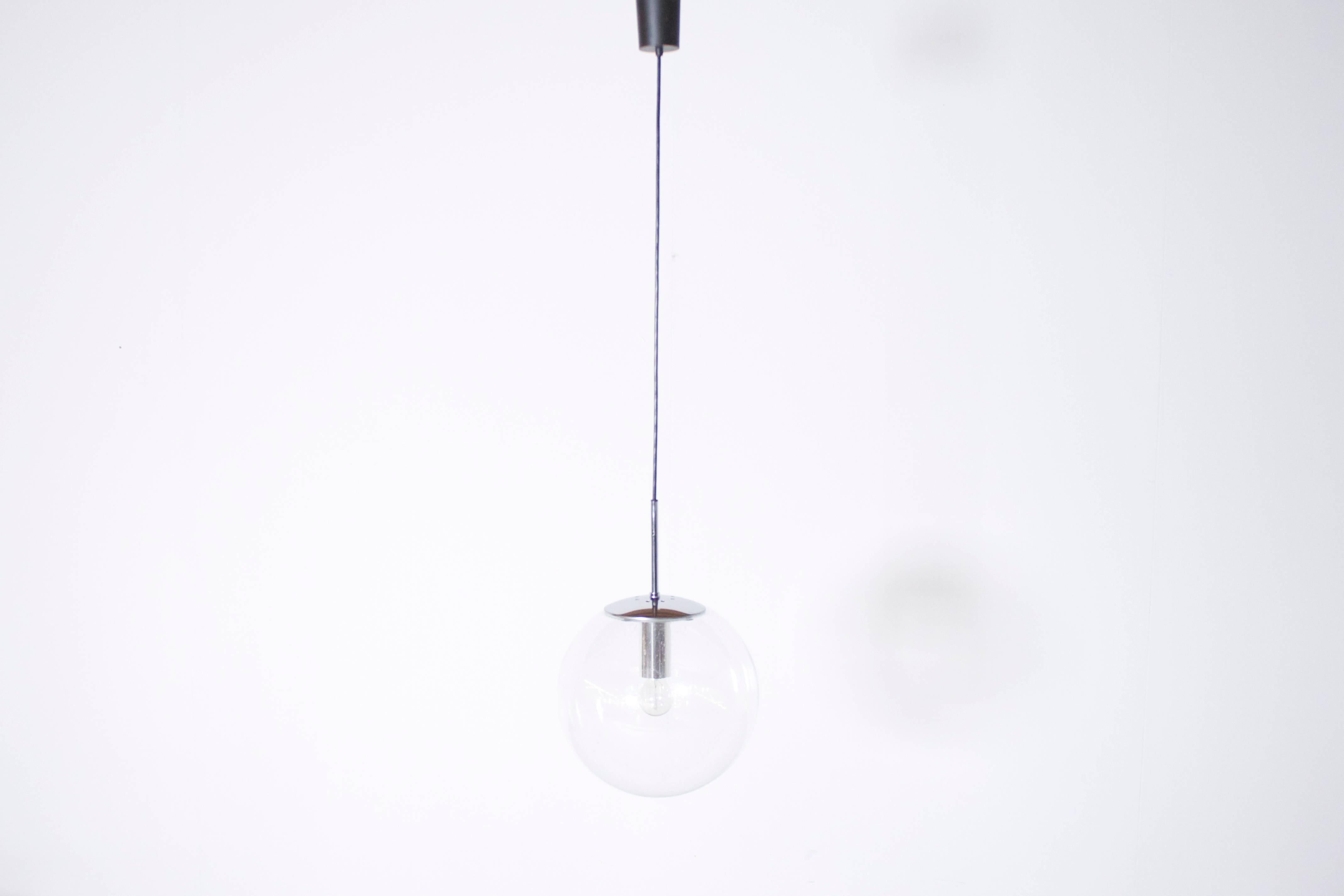 Large Glashütte Limburg pendants in beautiful condition. 

Chromed hardware. 

Handblown transparent bubbled glass globes which create a wonderful light effect.

Black cord and original canopy. 

The length of the cord can be customized for
