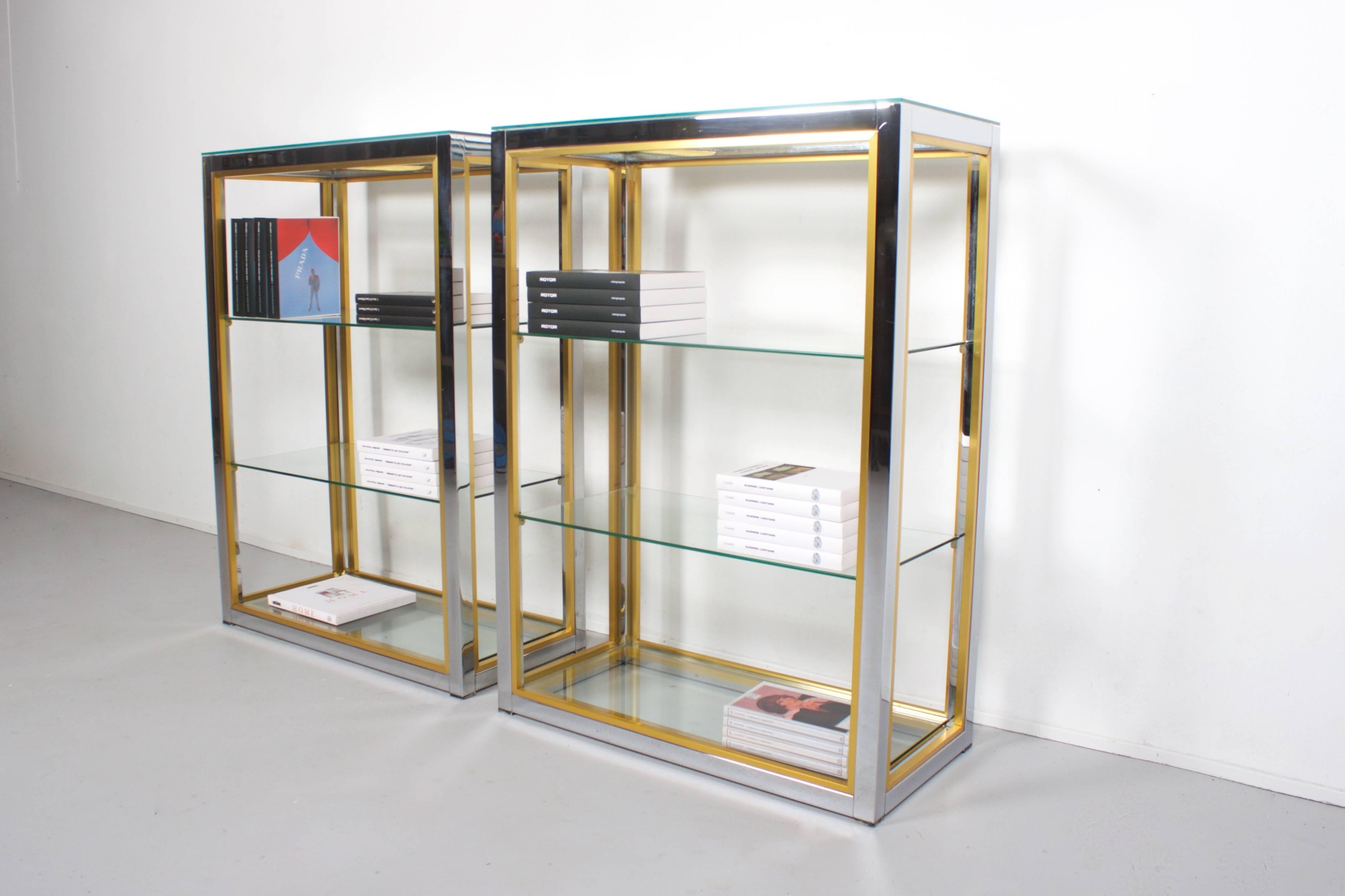 Two étagères by the Italian designer Renato Zevi in very good condition.

Chrome structure with contrasting brass details.

Four glass shelves of which one is situated at the base.

Can also be used as a room divider. 

If you have any