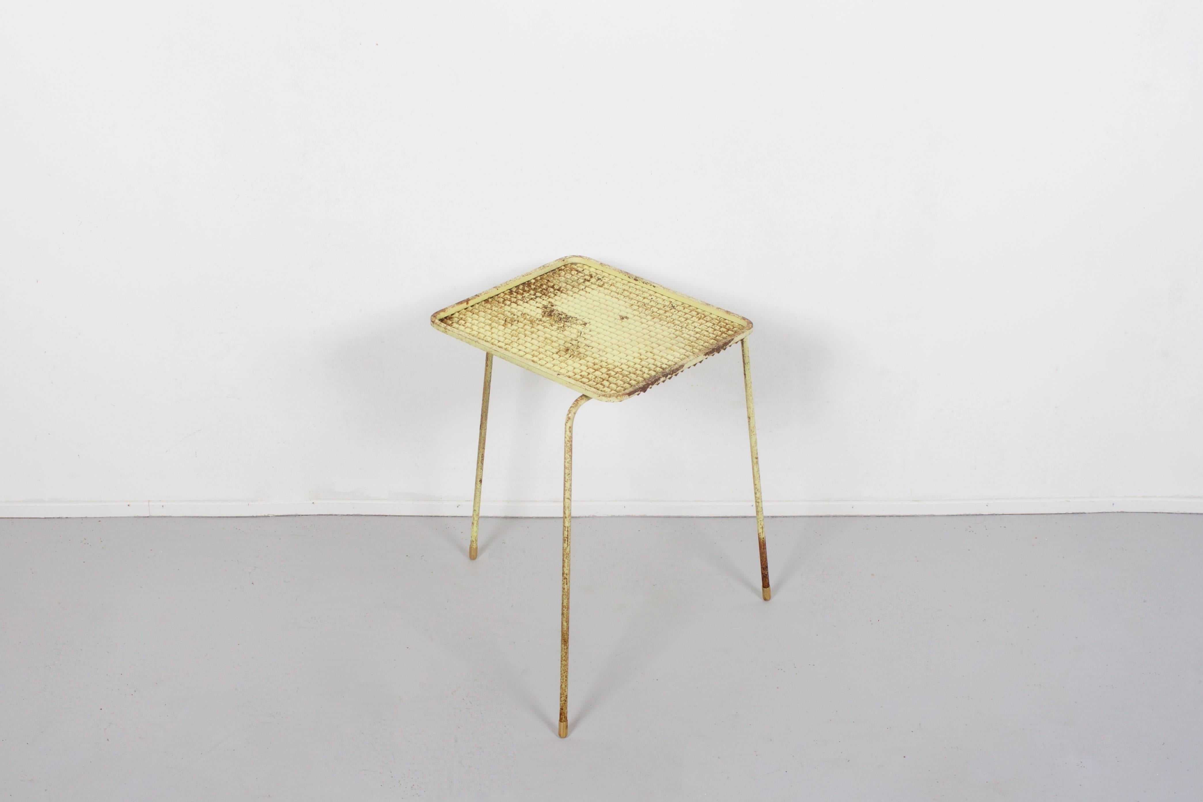 All original Mathieu Matégot 'Soumba' nesting tables in orange, black and yellow.

These tables are in original condition.

The metal table tops are textured and supported by three metal legs.

There are small brass feet mounted on the end of