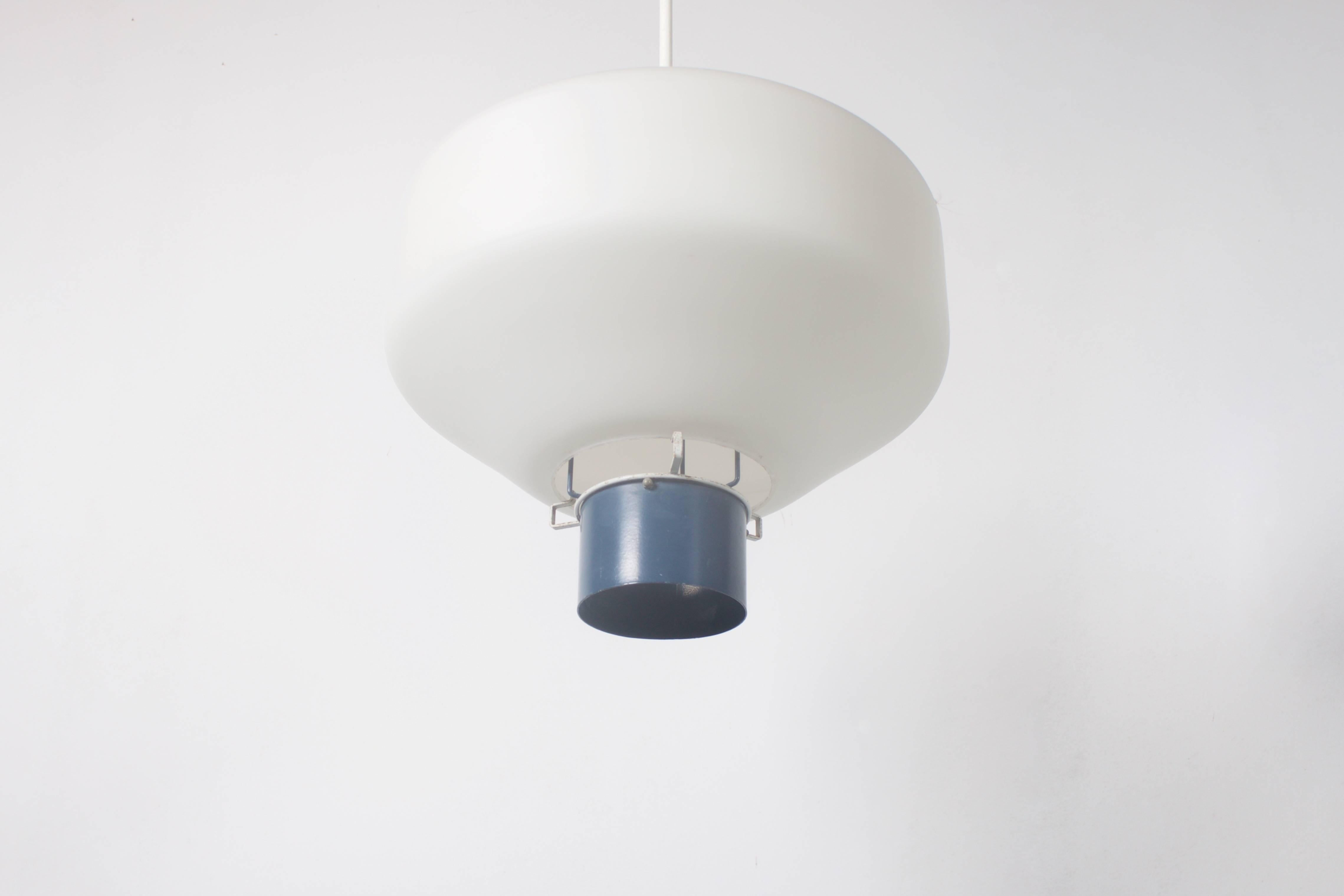Industrial Philips pendant in good vintage condition.

Two items available.

Design: Louis Kalff.

The opaline shade is held in place by a grey lacquered metal tube which also holds the lightbulb.

The lamp hangs by a white metal rod attached to the
