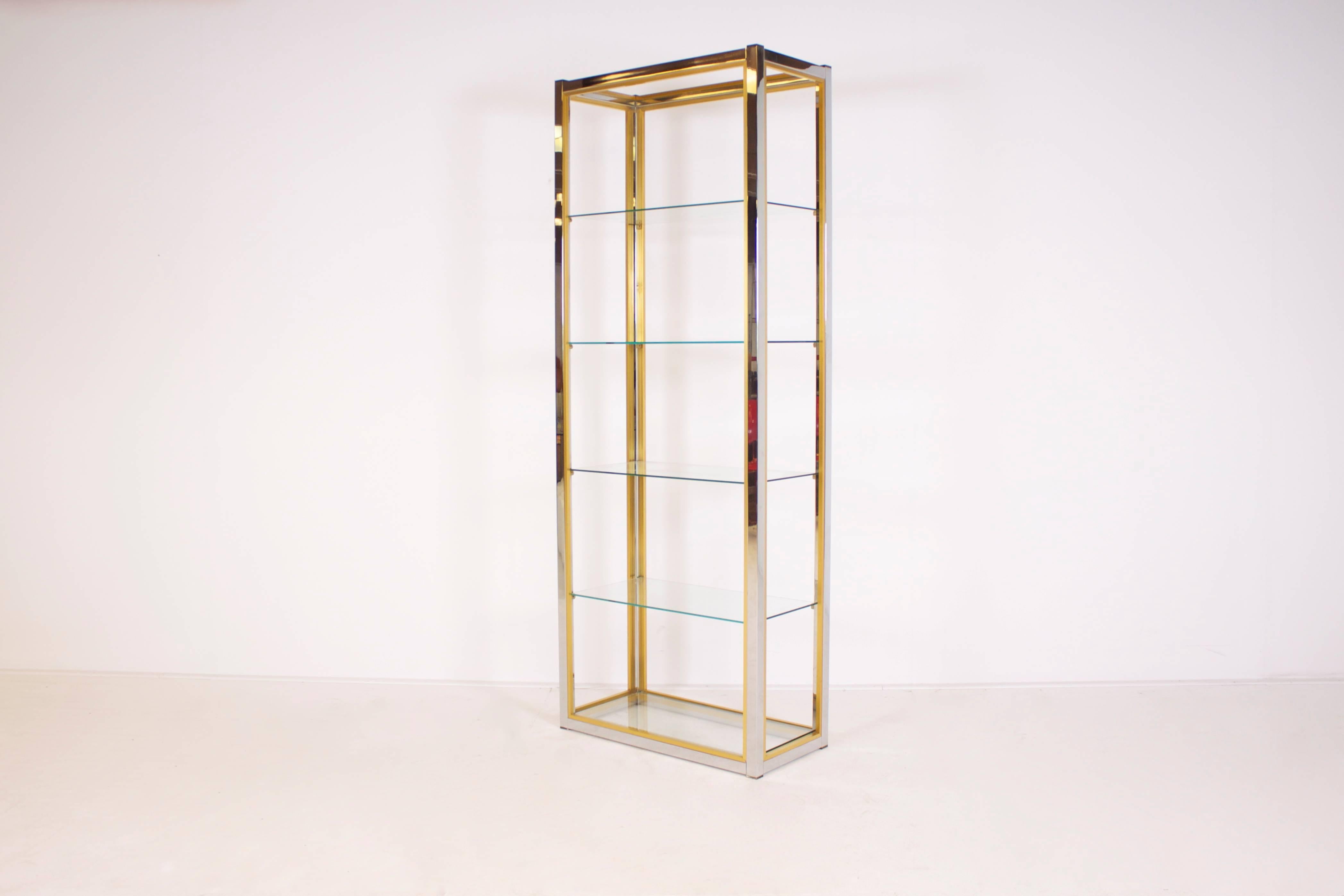 Large version étagère by the Italian designer Renato Zevi in very good condition.

Chrome structure with contrasting brass details.

Five glass shelves of which one is situated at the base.

Can also be used as a room divider. 

If you have any
