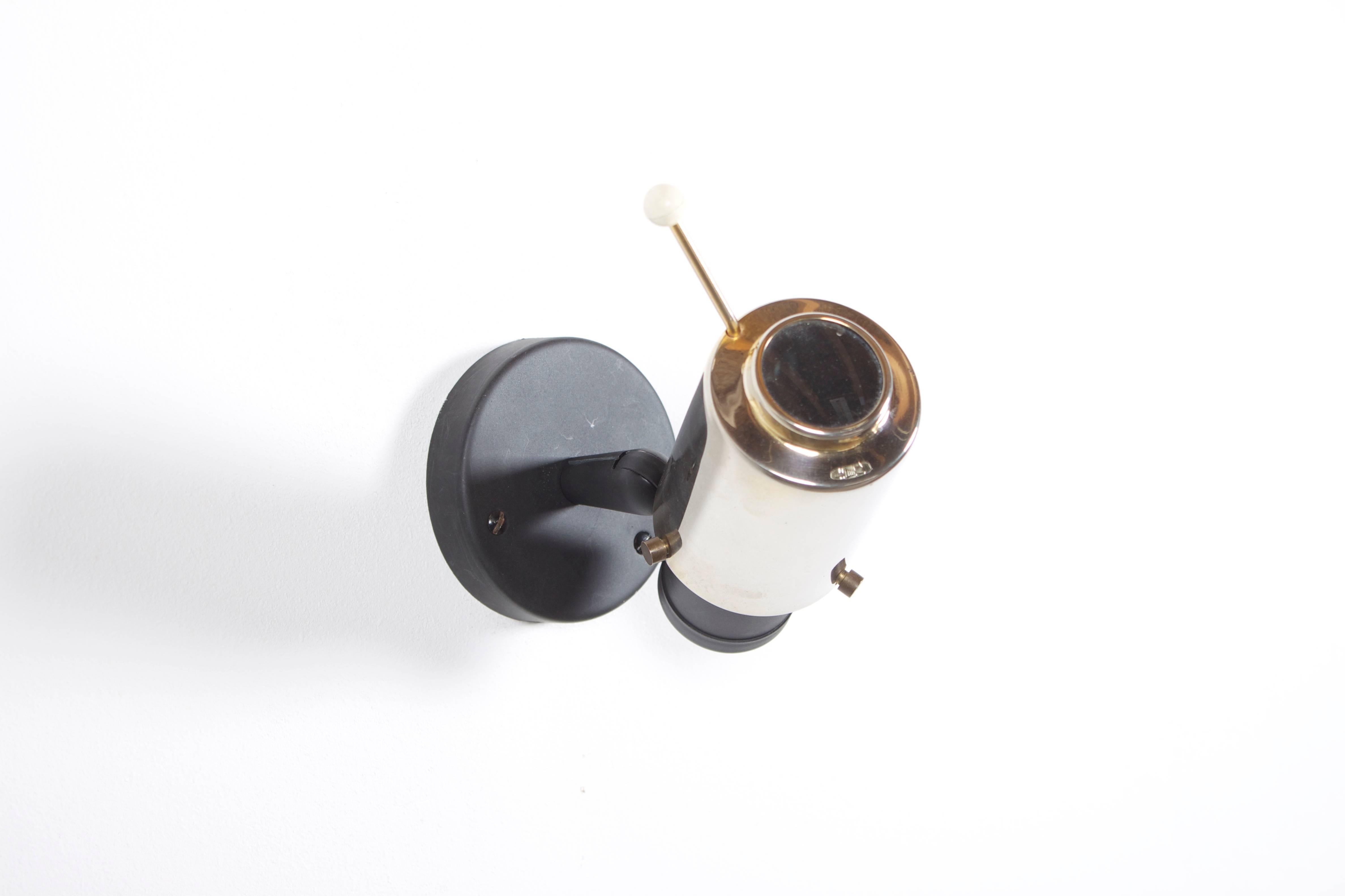 Nice wall lamp designed in the 1950s by Jacques Biny.

Manufacturer: Lita, France.

Shade: Polished brass with magnifying glass.

Wall mount: Black lacquered.

If you have any questions, please feel free to contact us.