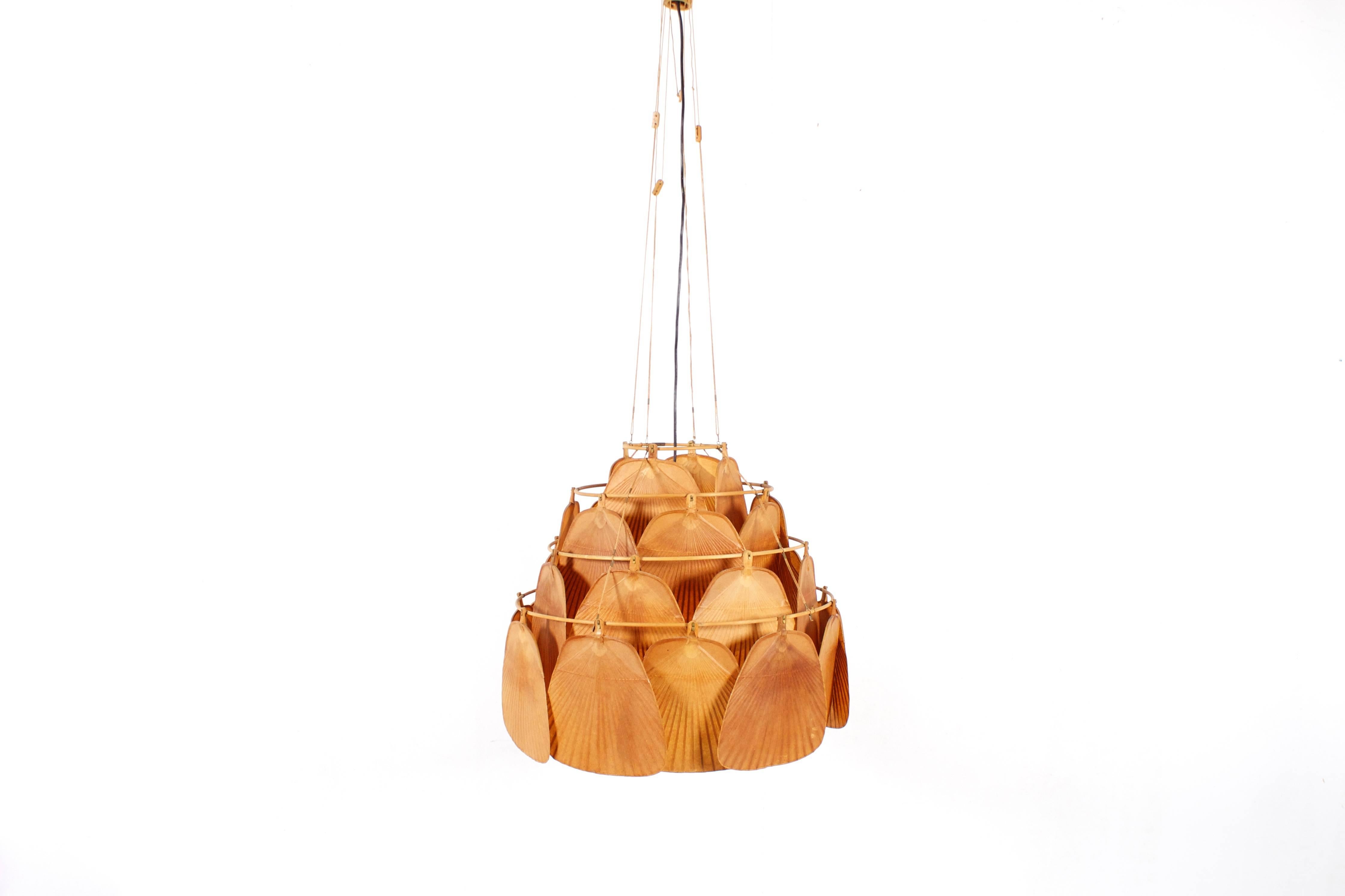 Largest version of the Uchiwa fan chandelier in very good original condition.

Designed by Ingo Maurer for M design, Germany.

This lamp is handmade from bamboo and Japanese rice paper. 

The lamp consists of 30 fans hanging from a four-tier