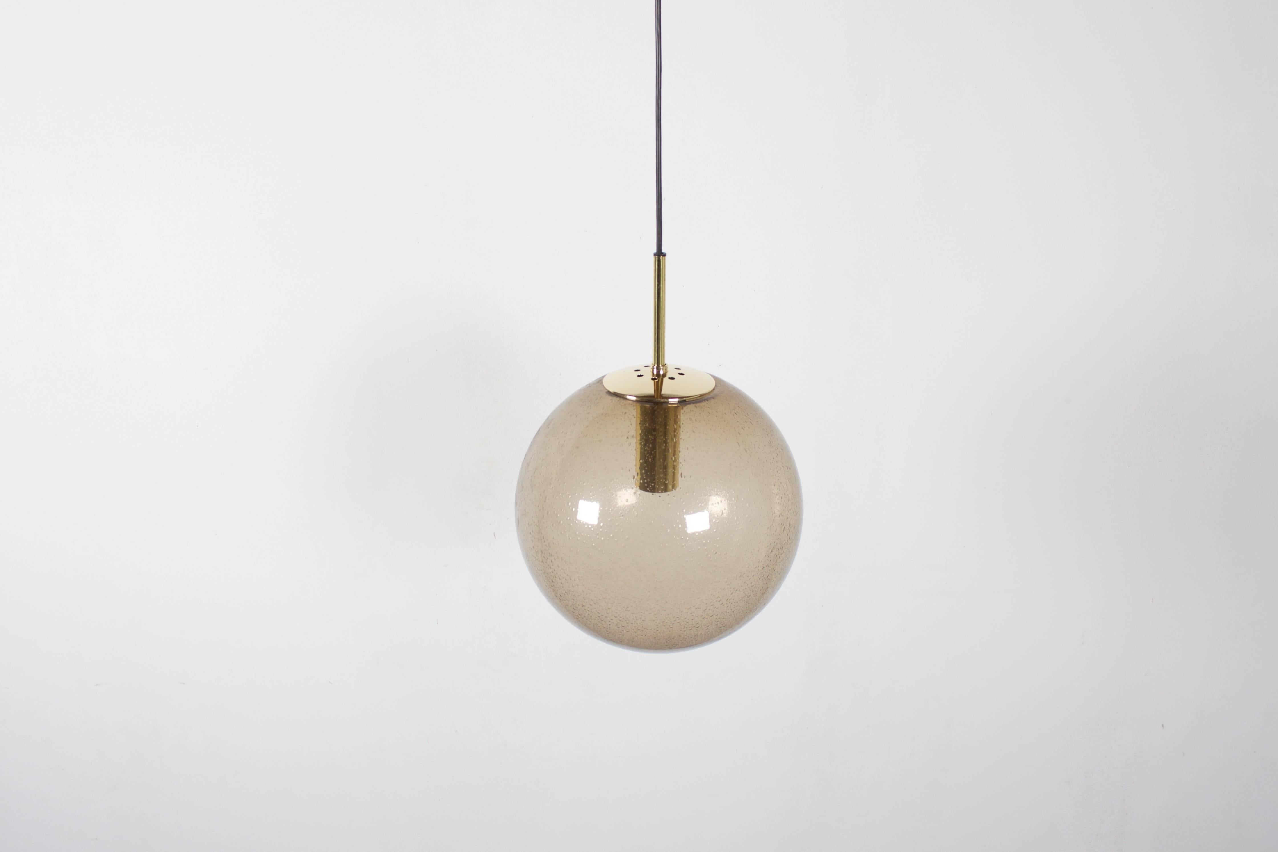 Three available (priced individually)

Brass hardware.

Handblown transparent bubbled smoked glass globes which create a wonderful light effect. 

Black cord and canopy 

The length of the cord can be customized for free. 

Marked: Glashütte