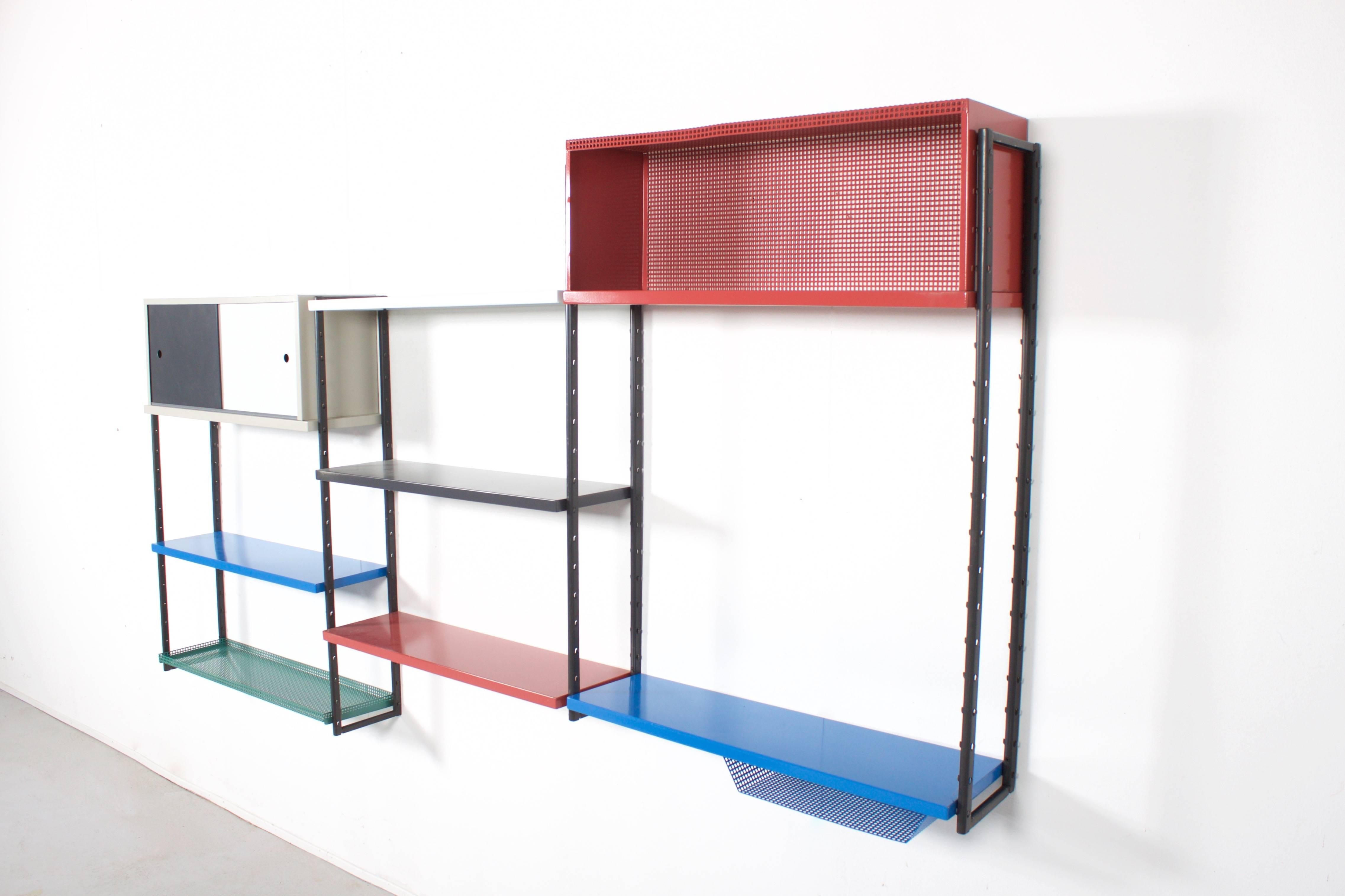 High quality metal wall unit attributed to Mathieu Mategot in very good condition.

This wall unit consists of:

Four multicolored metal shelves
One perforated metal shelve 
One metal shelve with a perforated 
One two-door cabinet 
One perforated