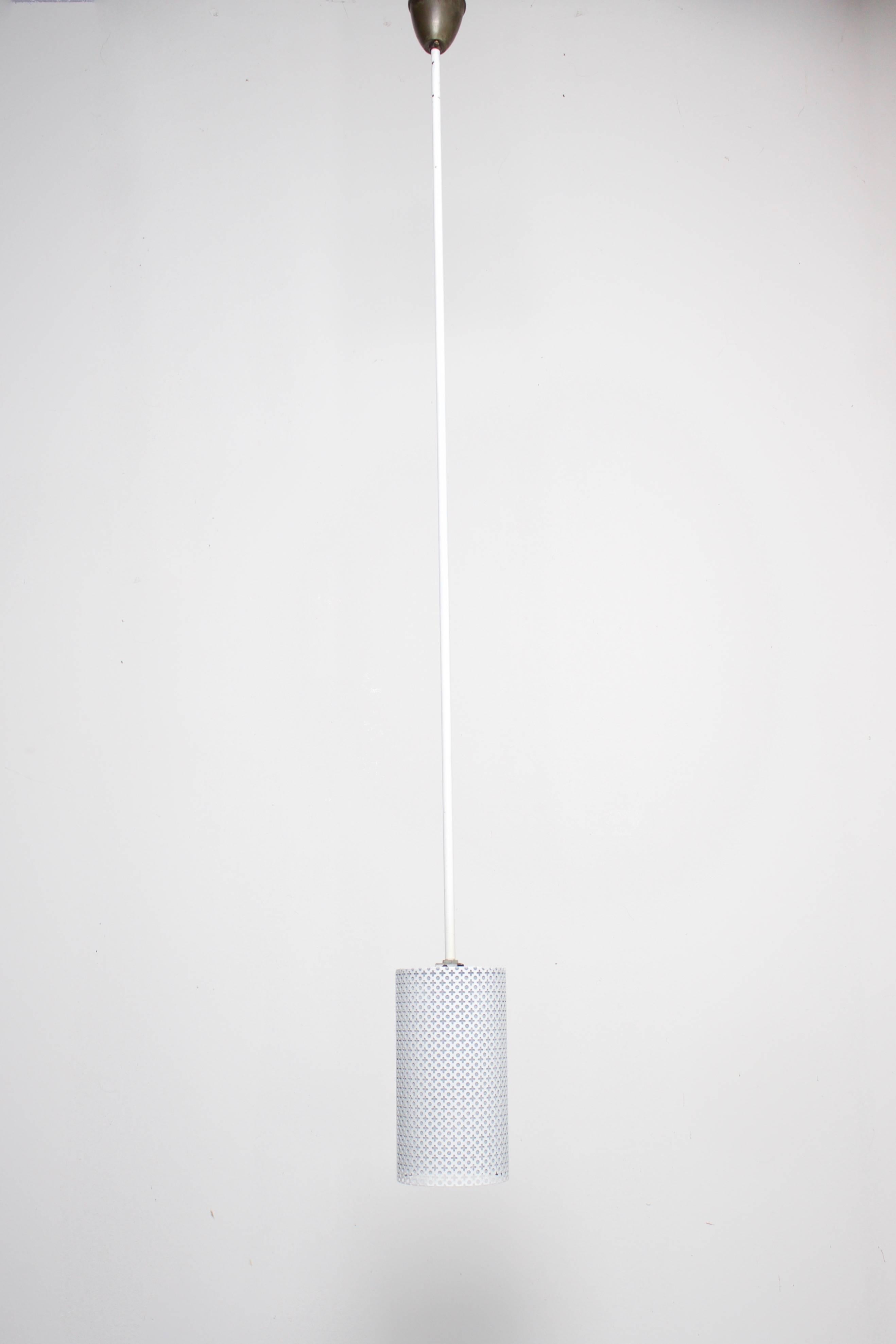 Six white metal pendants by Mathieu Matégot in very good condition

White perforated metal shades with the typical Matégot cross / hole pattern

The shades hang on a white lacquered metal rod with a copper ceiling plate.

The rods can be made