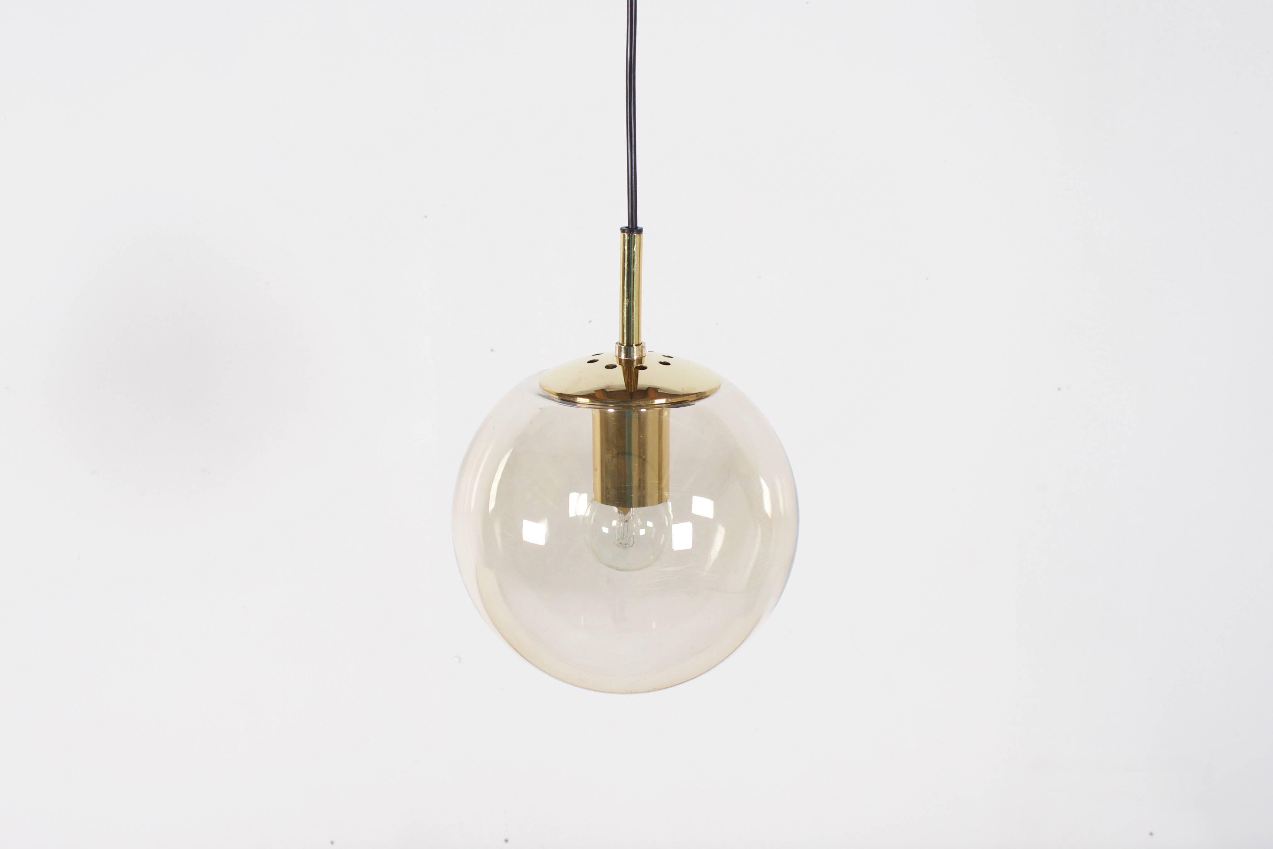Glashütte Limburg pendants in beautiful condition. 

Brass hardware. 

Handblown clear glass globes which give a warm light effect, 25 cm in diameter 

Black cord and canopy. 

 The length of the cord can be customized for free. 

Marked: