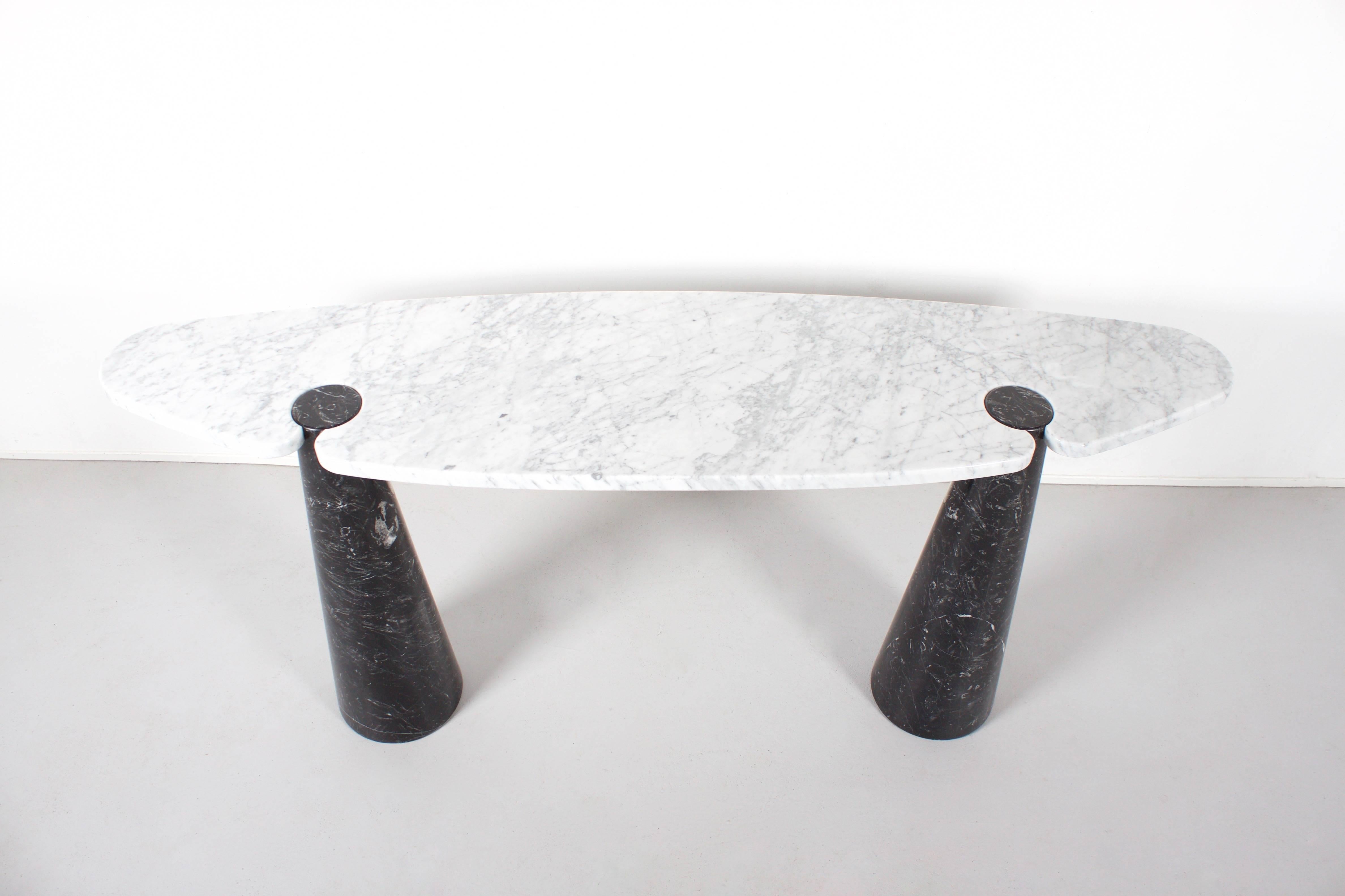 Fantastic ‘Eros’ Console in excellent condition.

This particular table consists of a white Carrara marble top and black Marquina marble conical bases.

The structural design of the Eros tables incorporate a gravity-based embedding between the table