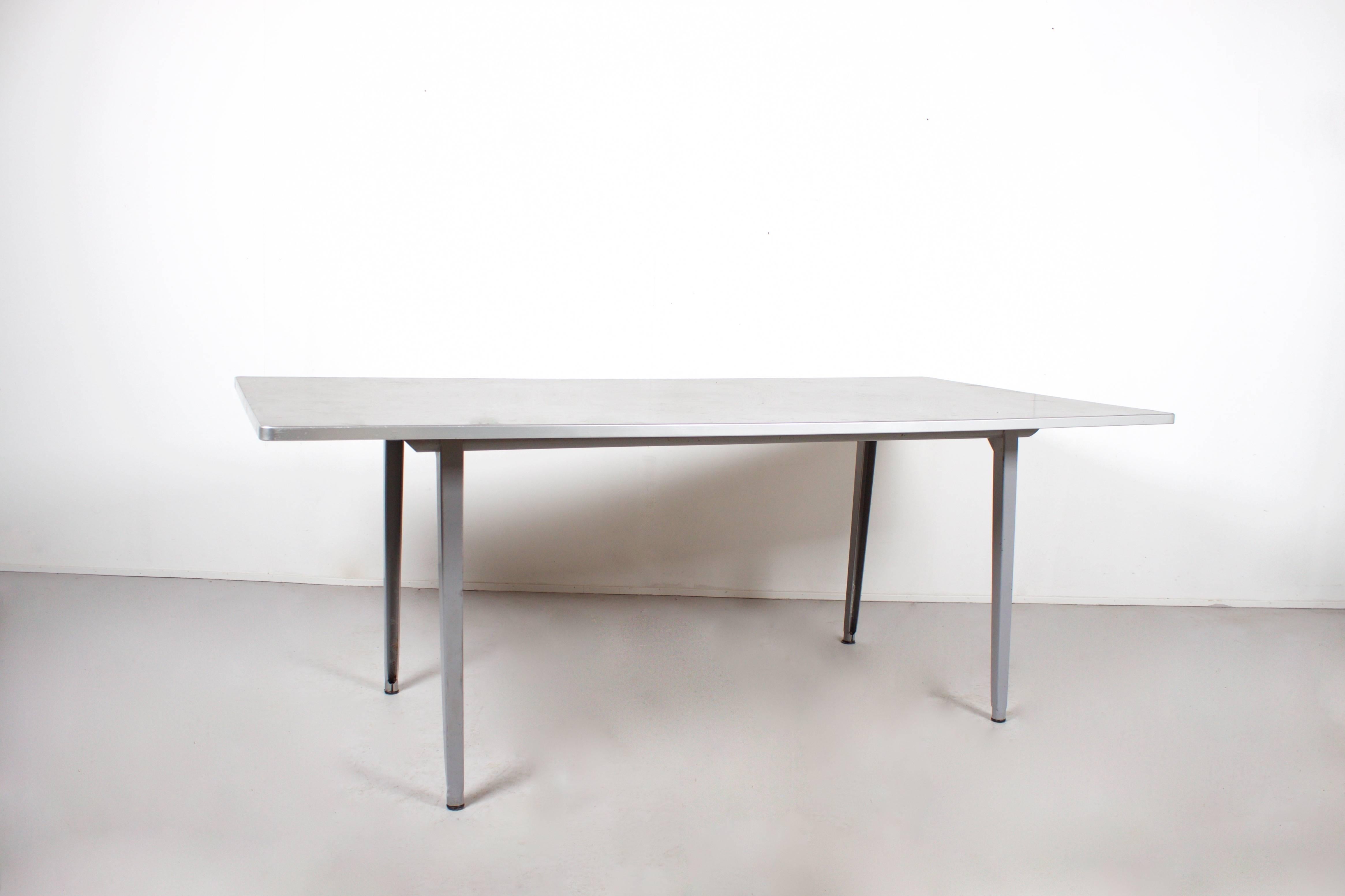 Hard to find large version of the Reform table by Friso Kramer.

Measurements: 200 x 100 cm. (LxW)

Manufactured by Ahrend de Cirkel during the 1955’s

It has a grey lacquered metal frame.

The top is laminated with a dark grey linoleum and has a